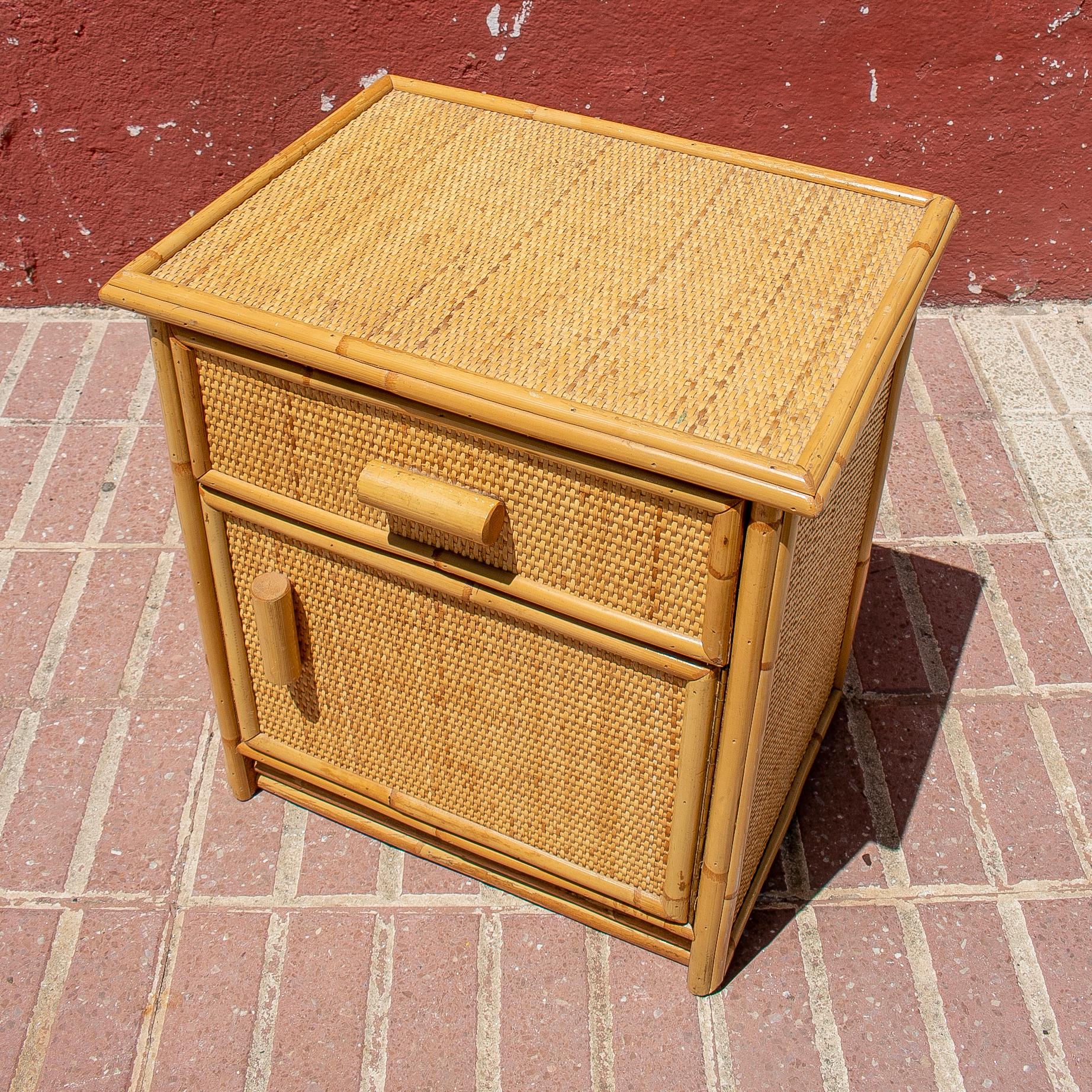 Pair of 1970s Spanish lace wicker and bamboo 1-drawer and 1-door bedside tables.