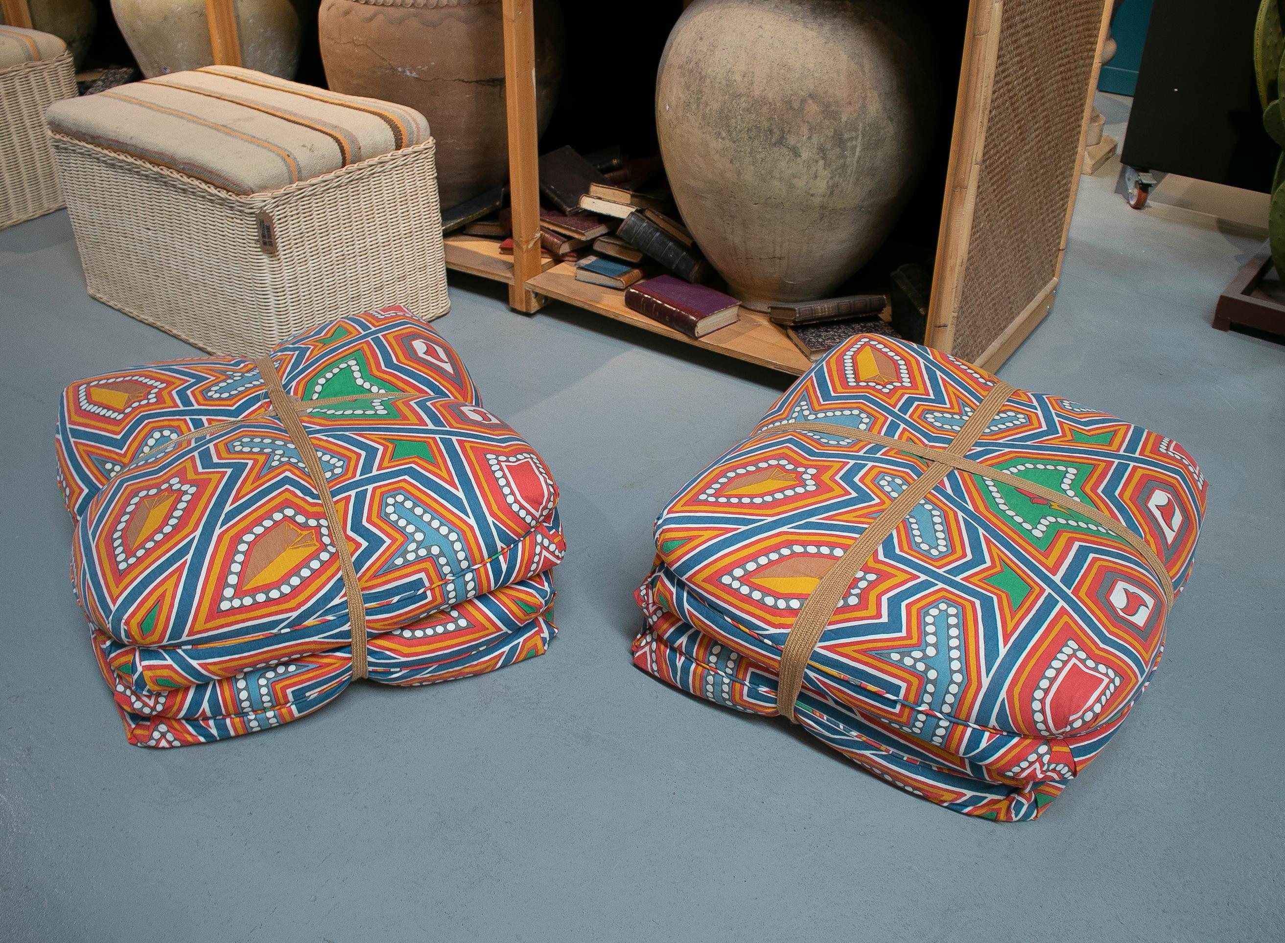 Pair of 1970s Spanish puff seats with wooden base and patterned fabric upholstery.