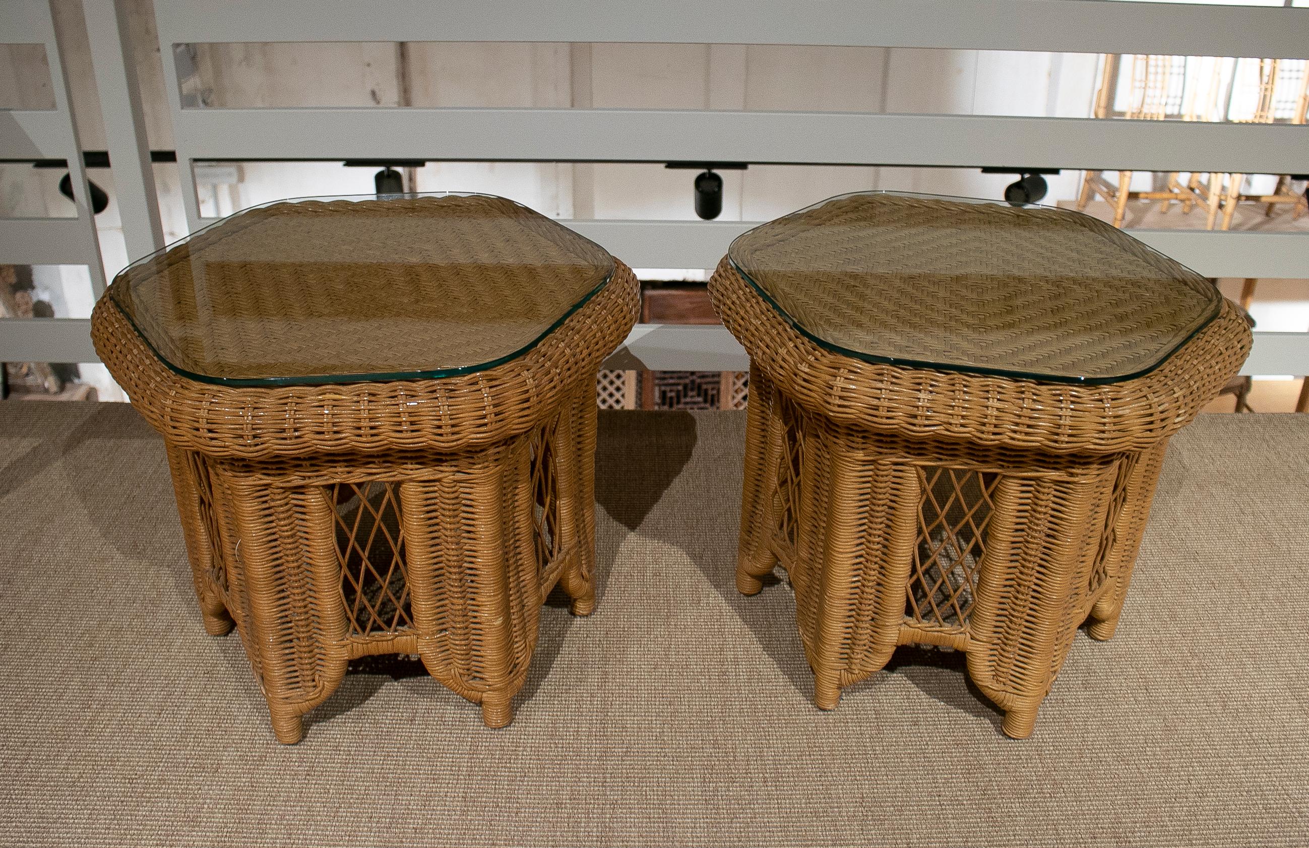 Vintage pair of 1970s Spanish round hand woven wicker side tables with glass top.