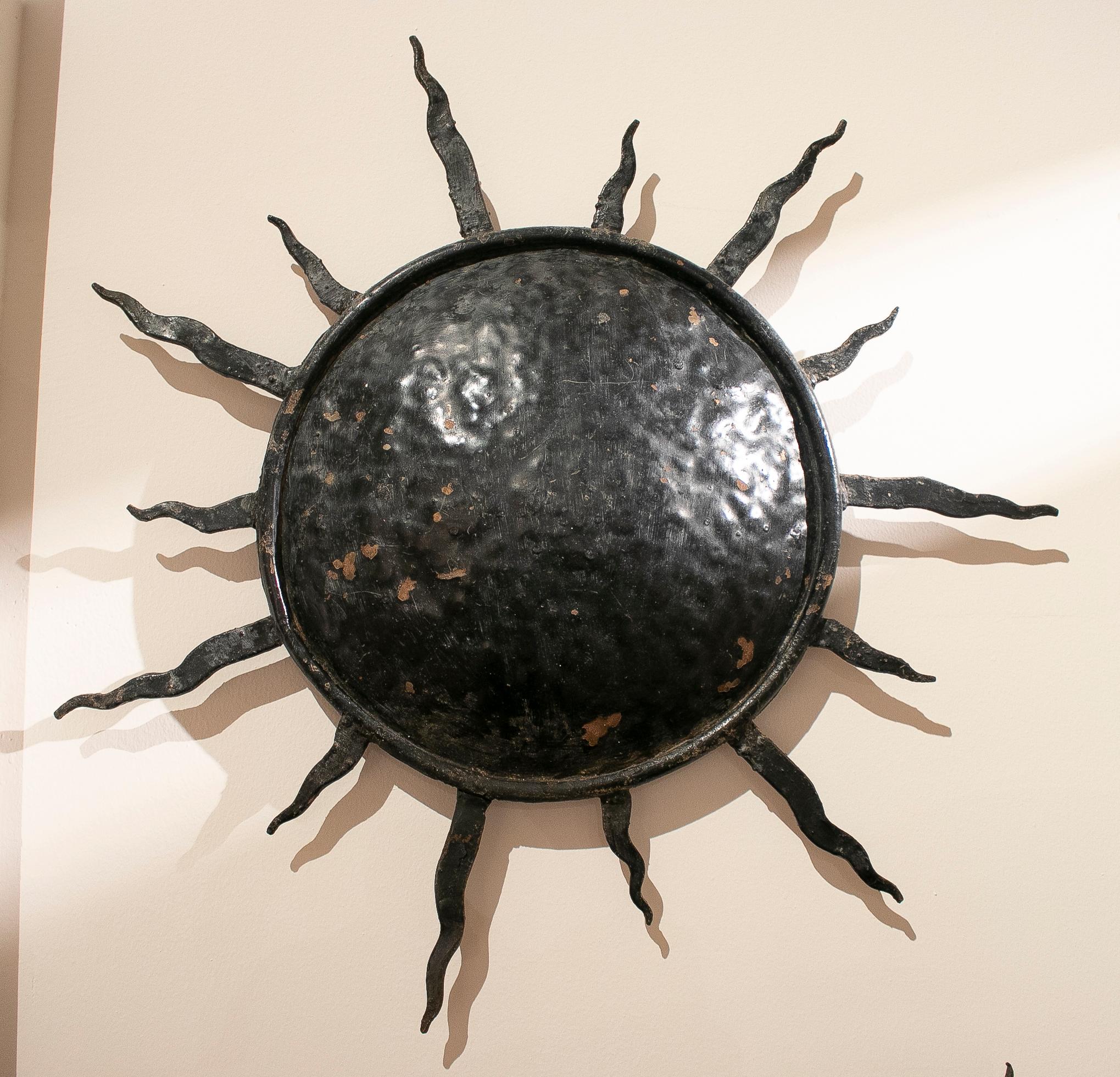Pair of vintage 1970s Spanish sun shaped wrought iron wall lamps.