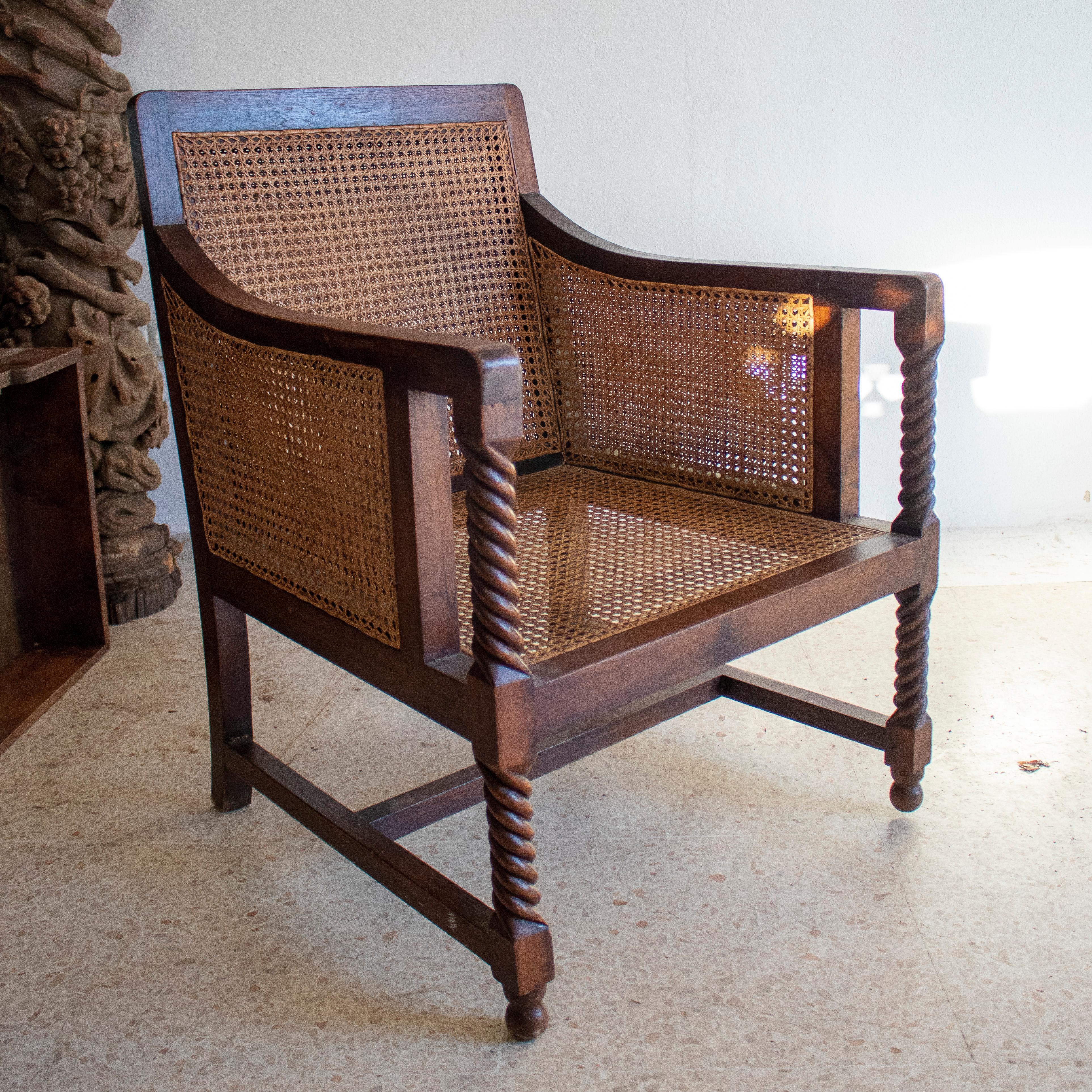 Pair of 1970s Spanish wood and woven cane sofa chairs with spindle armrest support.