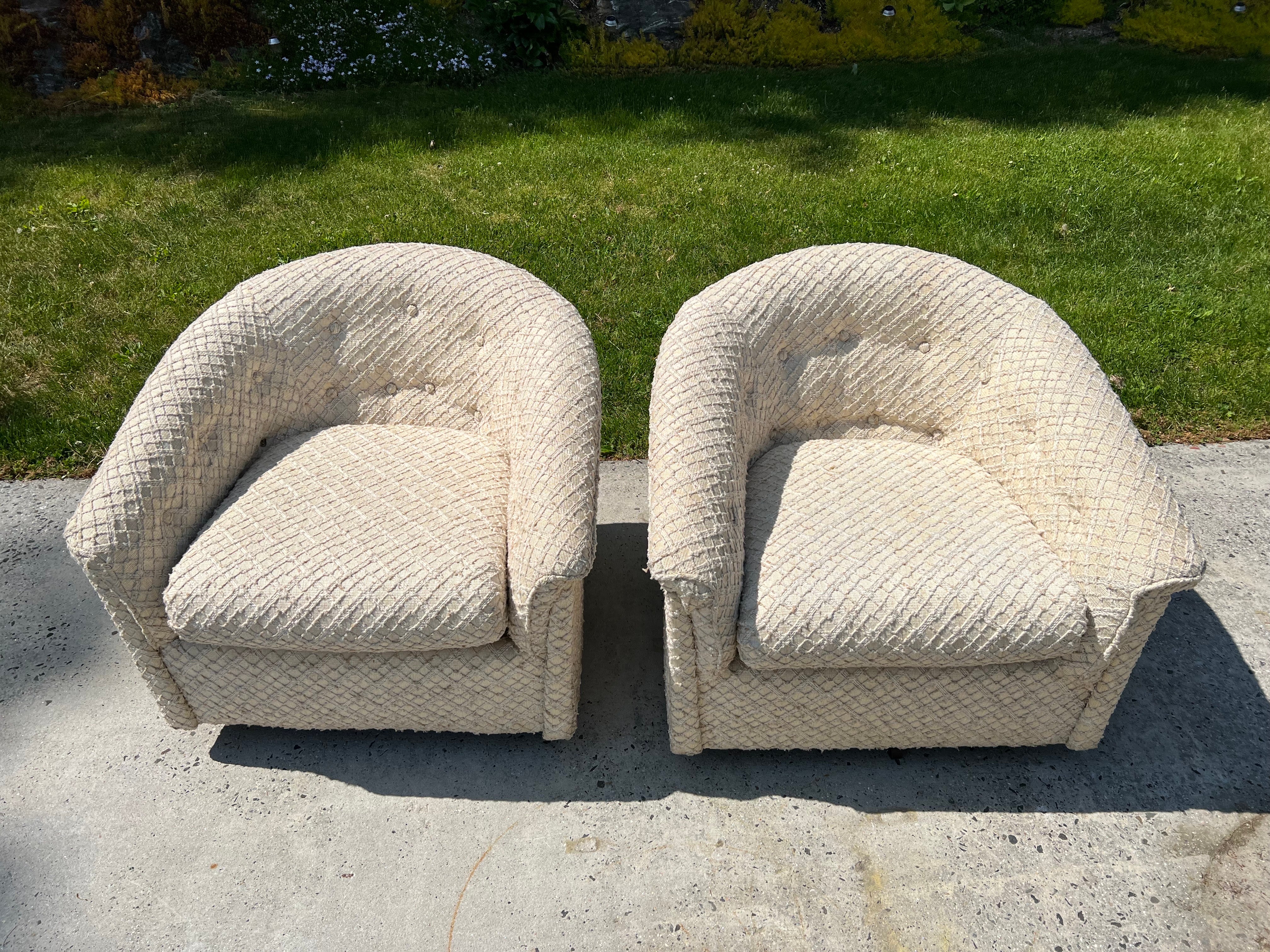 Pair of Solid 1970s Cream textured Swivel Chairs. Solid, well-made structured chairs. Great low profile and cube shape with woven textured cream upholstery. made by Stuart Furniture Industries. 
In 1963 Stuart Love established an upholstery
