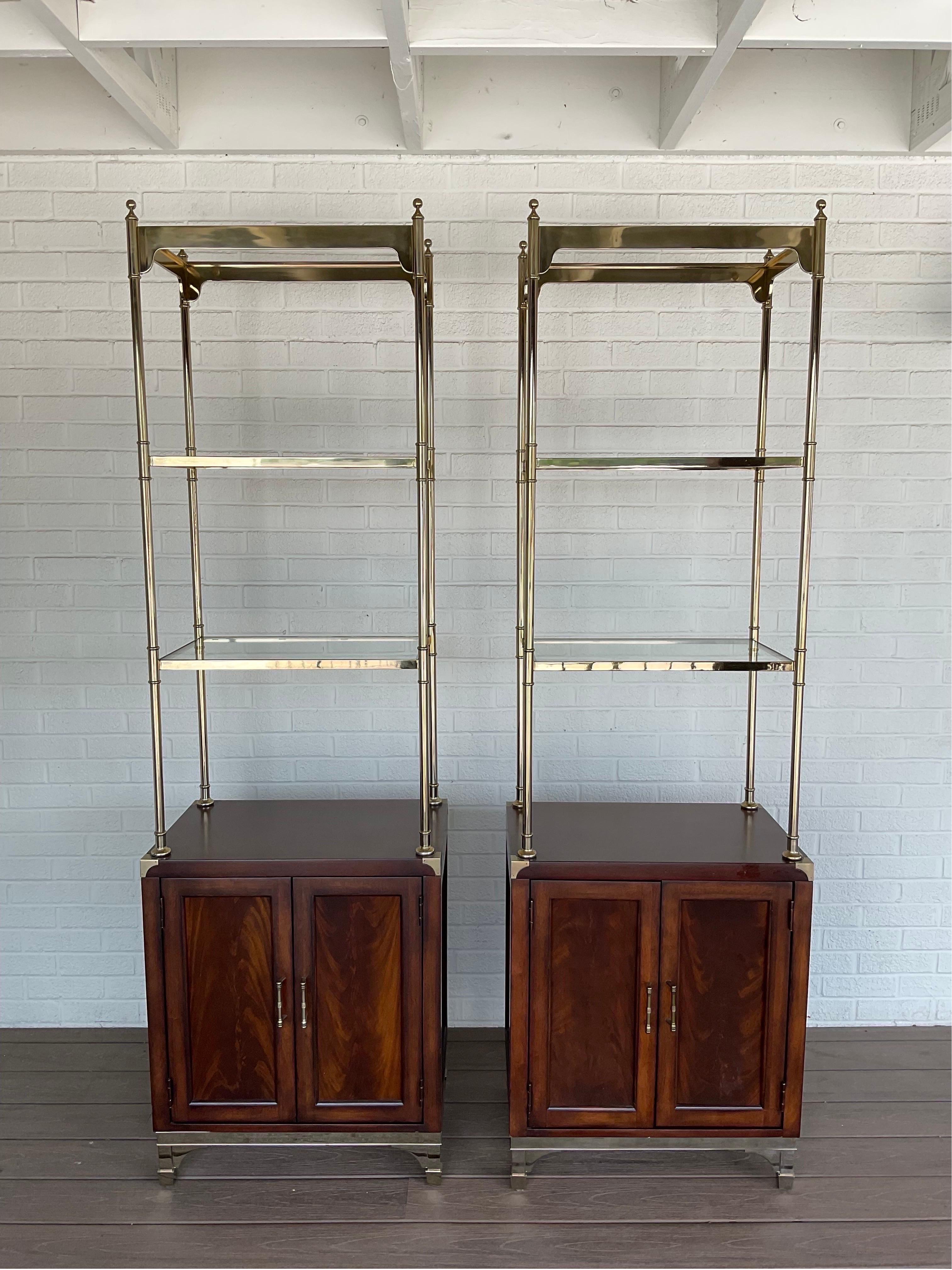 Spectacular pair of Mahogany and Brass Etegeres from Thomasville.  These original condition vintage beauties were made with cutouts for wires to travel between the shelves and out the backs making them idea to stow audio equipment or gaming