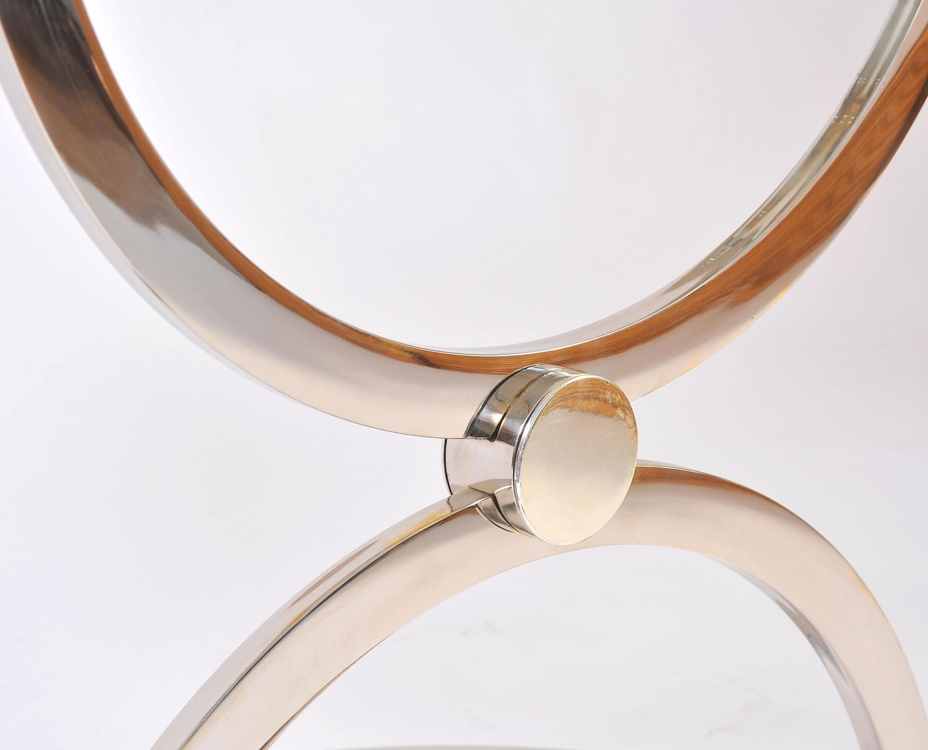 Chic, well-proportioned American circular chrome and glass side tables.