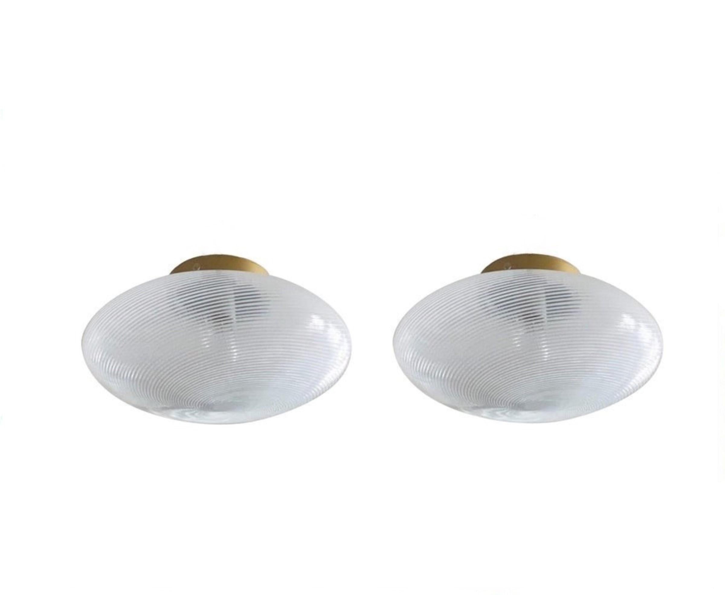 A pair of large flush mounts by Ludovico Diaz de Santillana for Venini, Series -Tessuto-, Italy, 1970s. Hand blown from white and clear Murano glass, brass mounted.
Each flush mount takes one E27 large sized bulb up to 100Watt. Both pieces in very