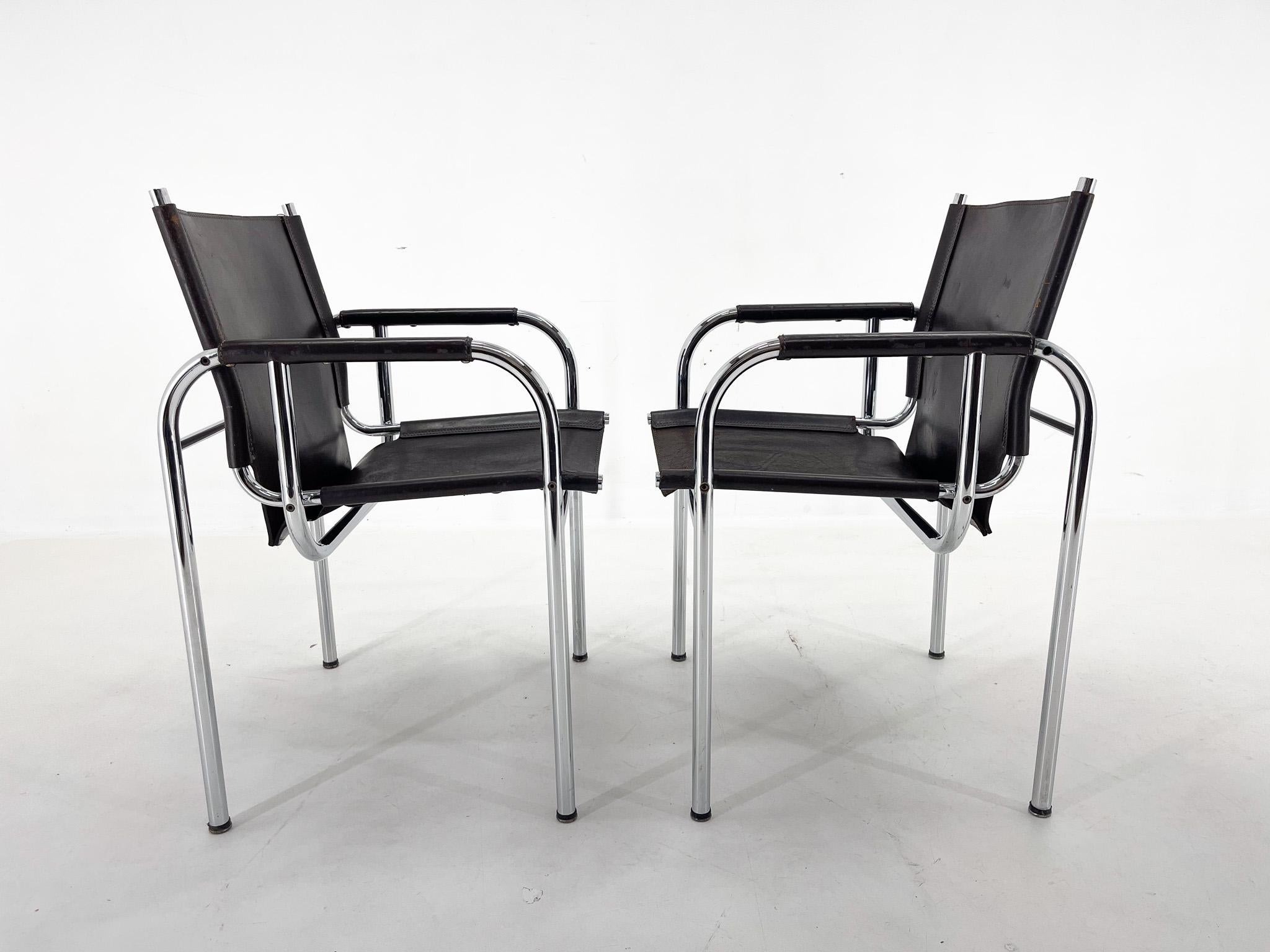 Set of two vintage chairs designed by Hans Eichneberger and produced by Strässle International in Switzerland in the 1970's. The chrome parts are in very good condition, the leather shows signs of wear, giving it a beautiful patina.