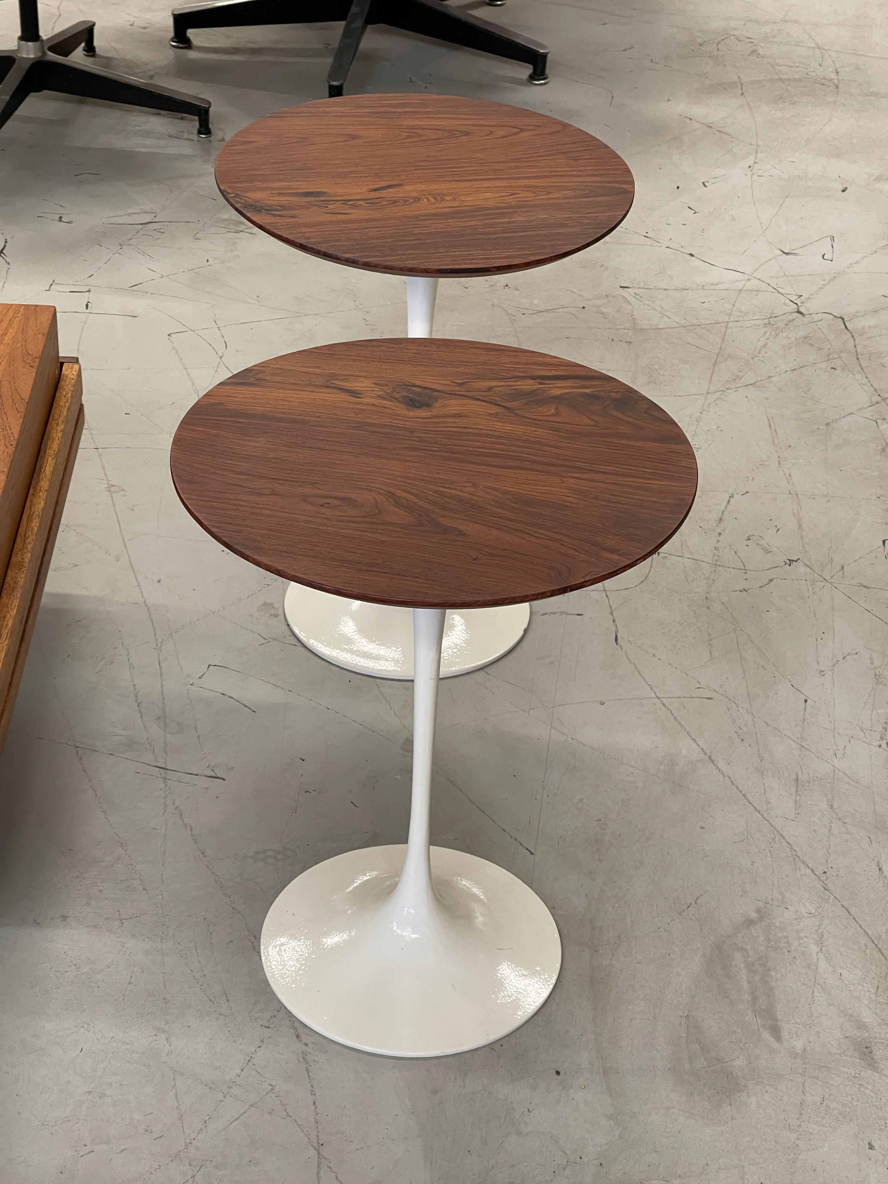 Beautiful pair of 1970’s Eero Saarinen tulip tables by Knoll. 745 Fifth Avenue label to one indicates 1970’s production. Nicely grained tops that have been refinished. The bases have tiny drill marks near the top as one has been affixed to the