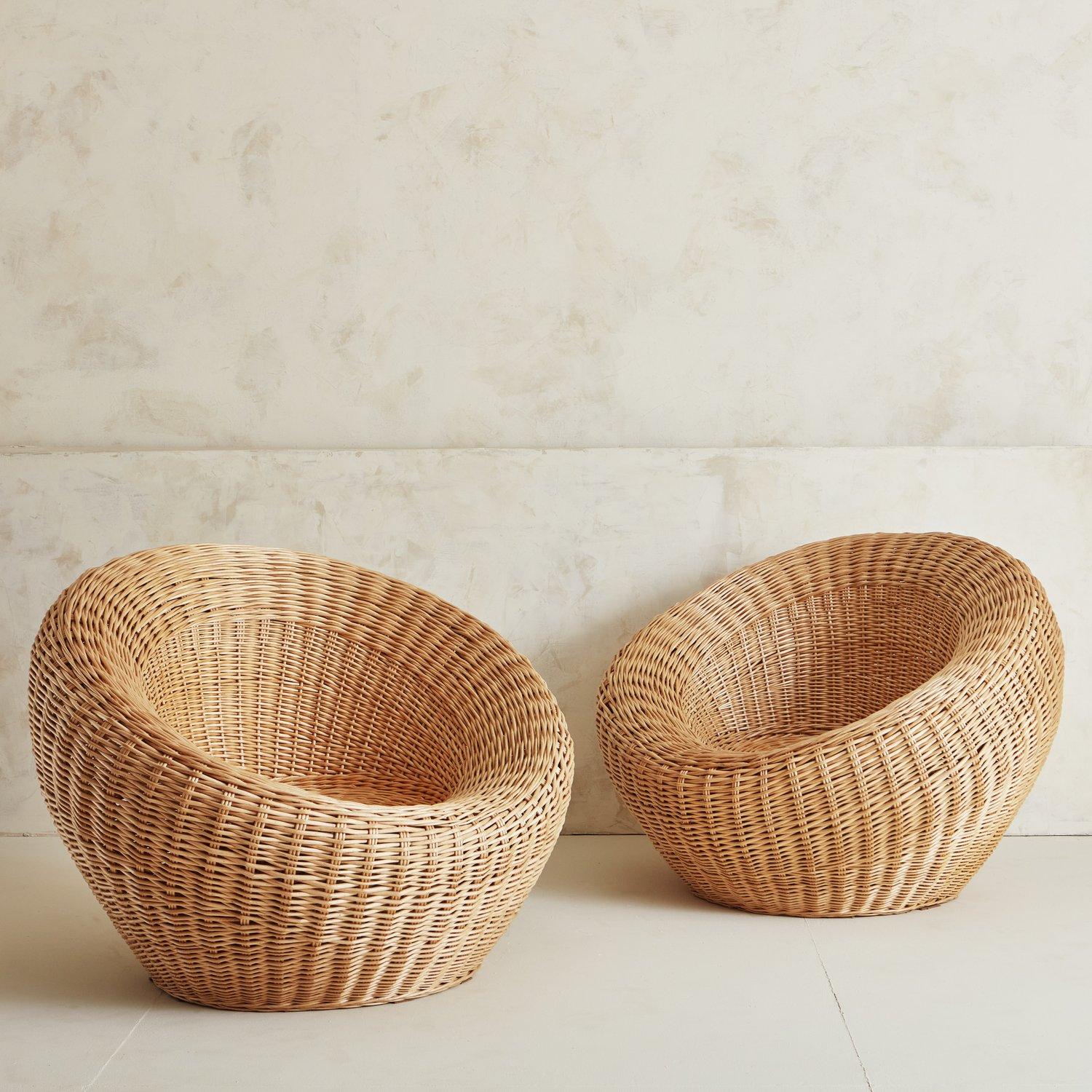 A gorgeous pair of rounded wicker lounge chairs in the style of Japanese modernist designer Isamu Kenmochi. These organic chairs are sculptural and elegant, featuring tightly woven rattan in a beautiful blonde hue. Sourced in Spain, 1970s.