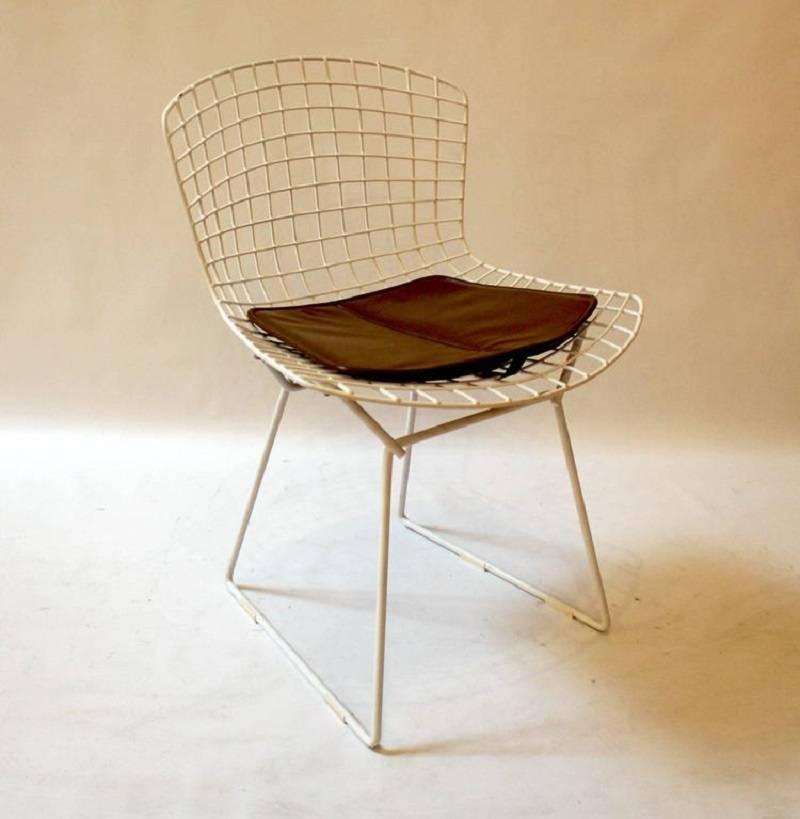 Pair of 1971 wire mesh side chairs by Harry Bertoia for Knoll. Chairs have their original seat pads and most have their original slides. Price is for the pair.
 