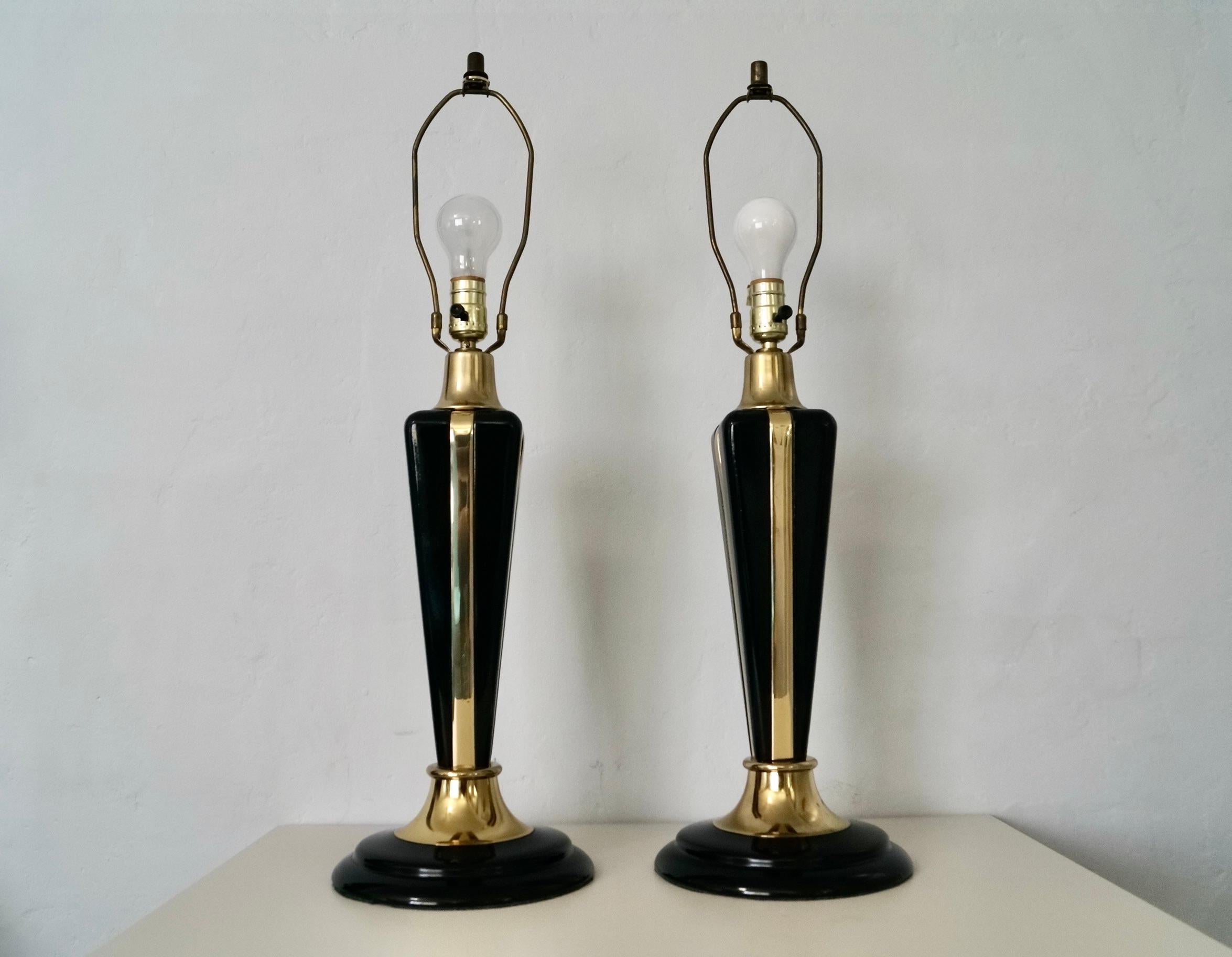 Vintage pair of 1980’s Art Deco table lamps for sale. They were manufactured in 1987, and made here in the US by Bella Lighting. They both still maintain the original maker’s mark sticker along with the date manufactured. They have a black metal