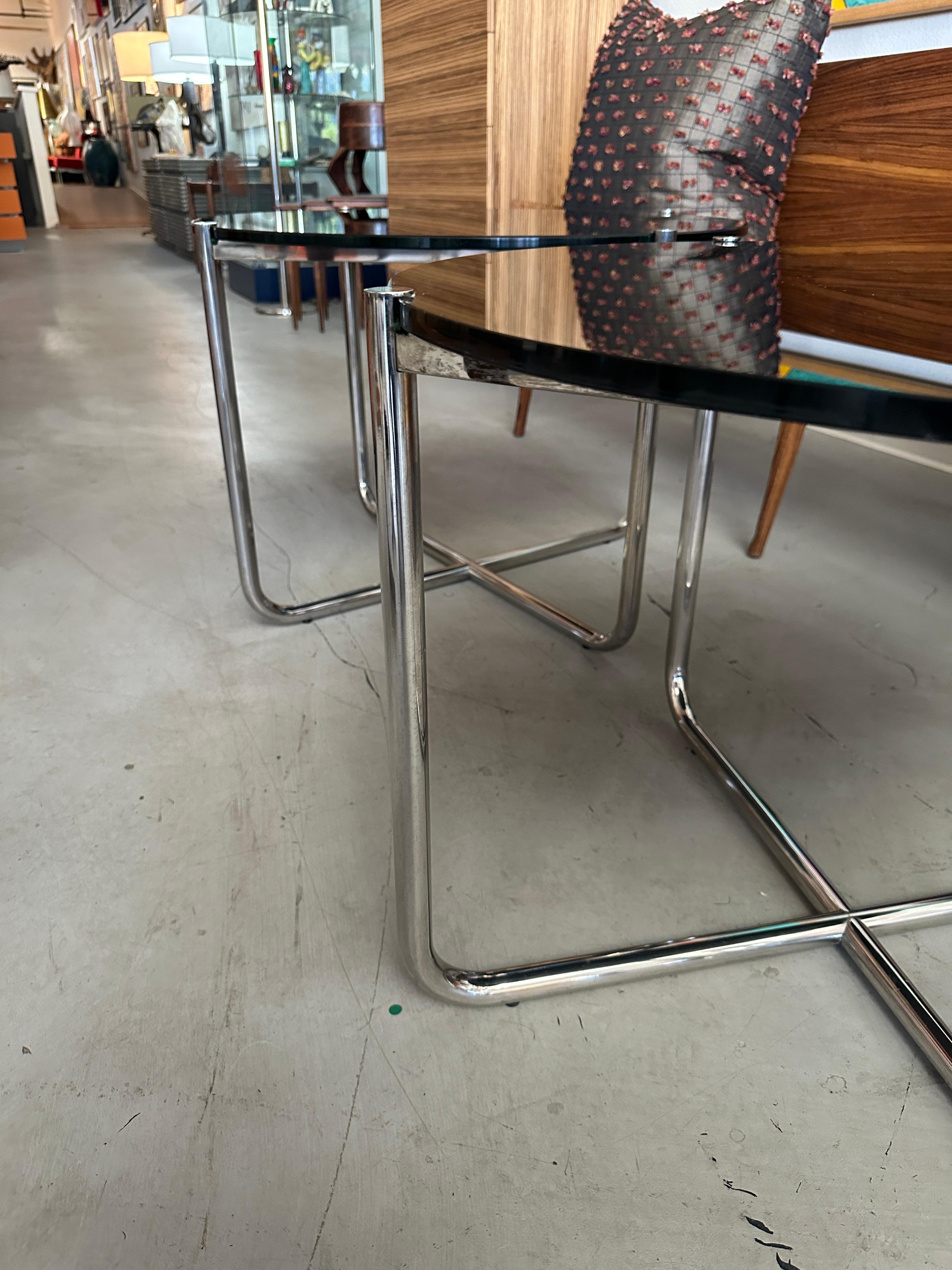 A beautiful pair of vintage 1980’s Knoll Mies van der Rohe MR tables with black glass. Chromed steel legs. One table has an intact Knoll Made in Italy label, the other has a partial remnant. The glass is in good clean condition, with only a few