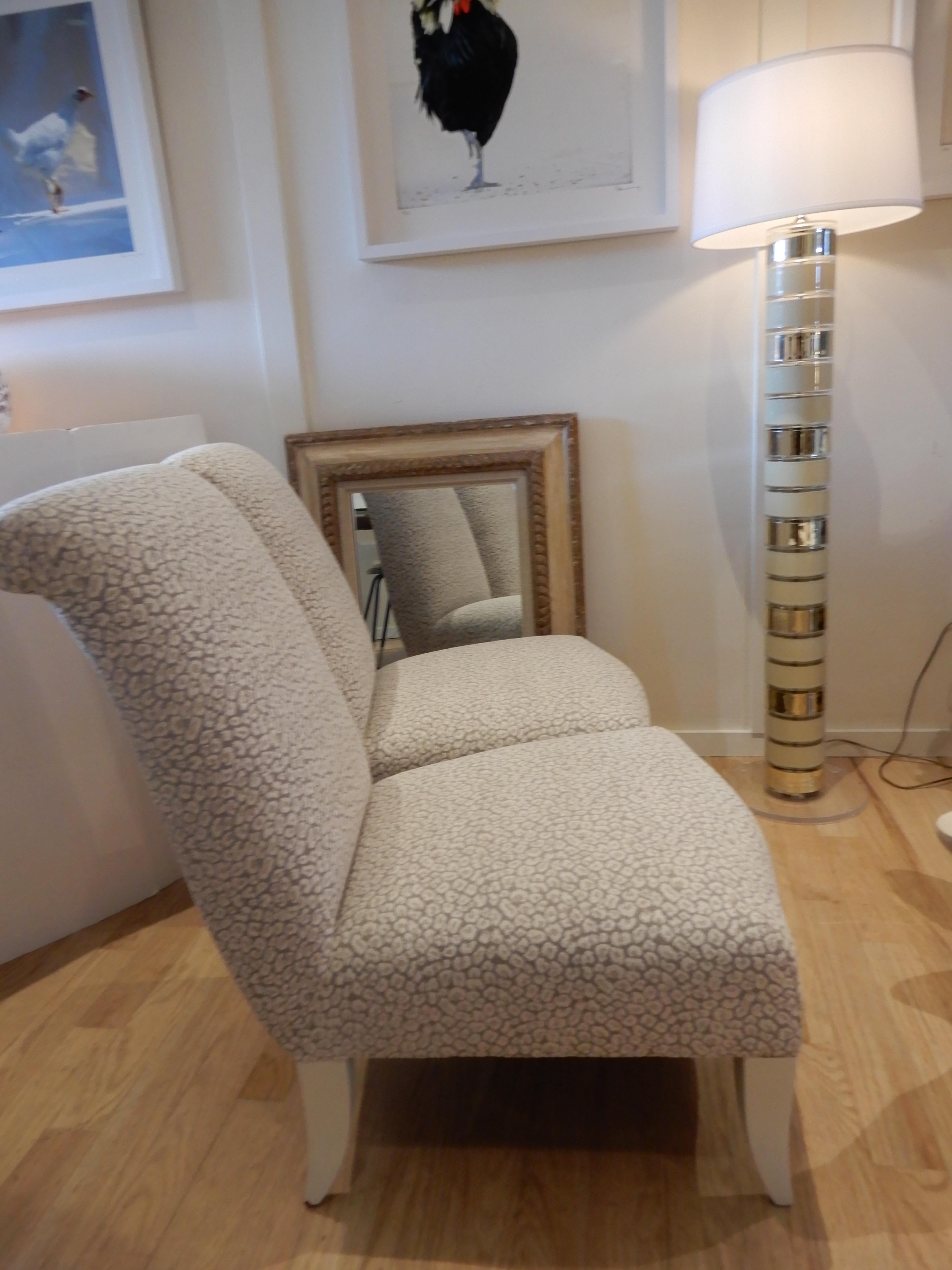 Stunning pair of newly upholstered Donghia slipper chairs/side chairs, in a Clarence house animal print luxurious fabric. Rolled head rest, painted legs in a bone beige.Priced for the pair.