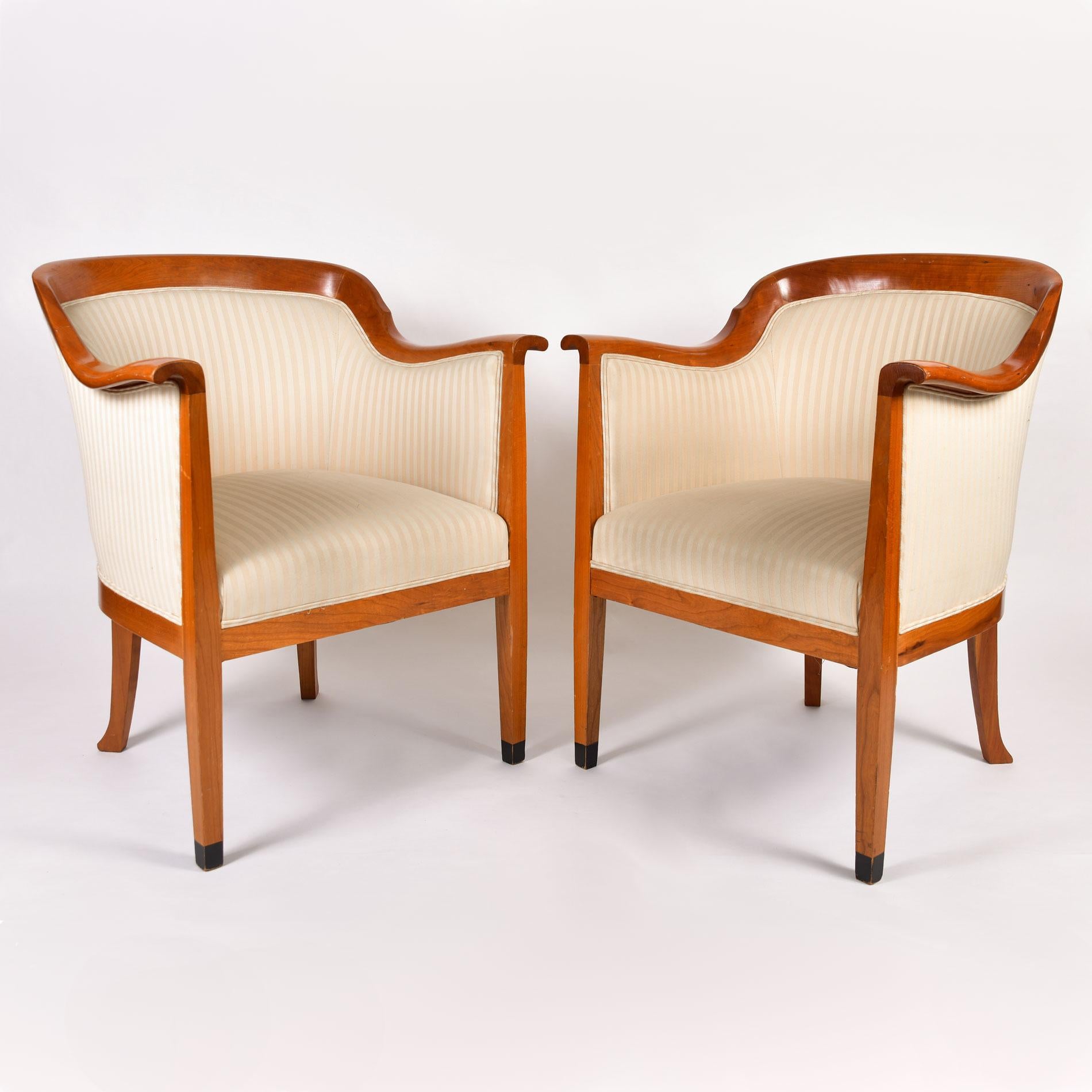 Generous and comfortable pair of occasional chairs with cherrywood tapered legs and frame. Black painted front feet. Upholstered in substantial cream striped fabric on all sides with double piping detail throughout.
Please note the fabric is scuffed
