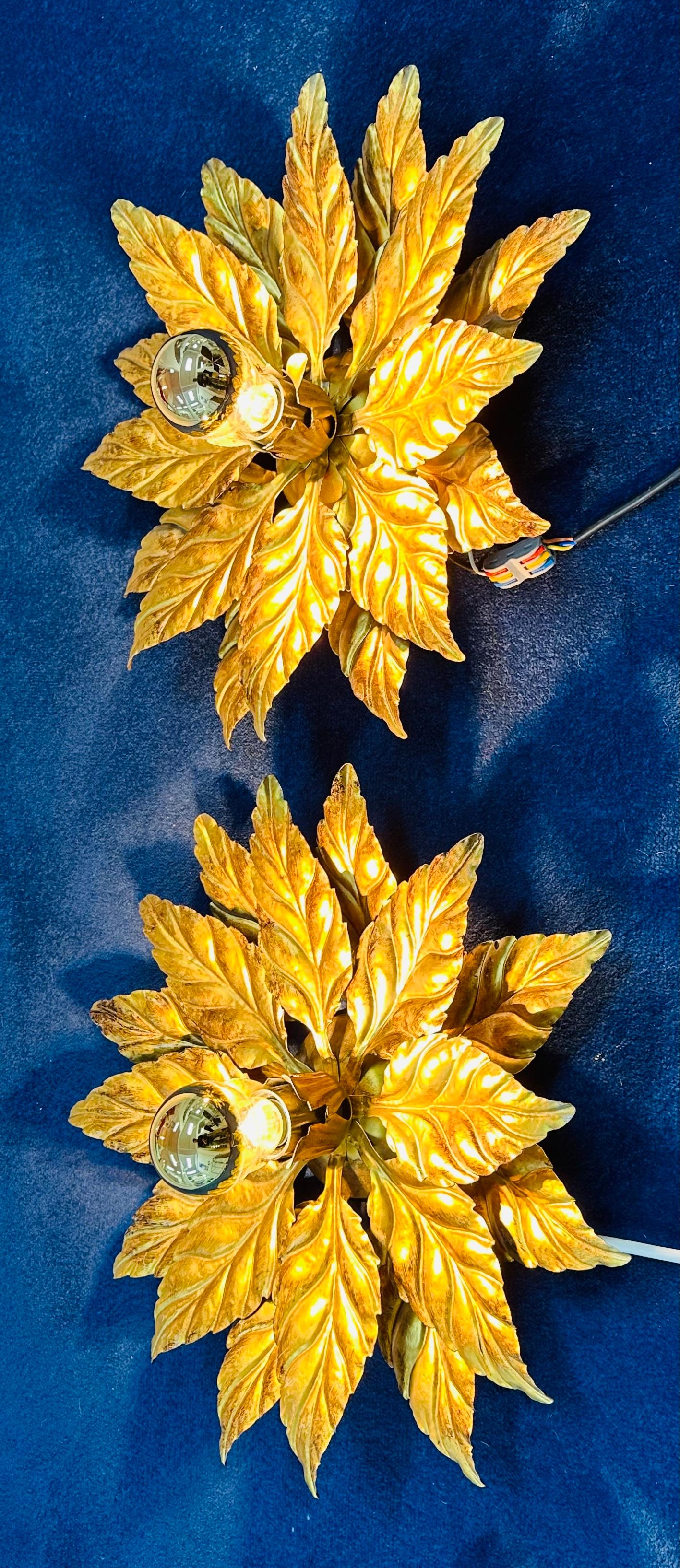 Pair of rather glamorous golden-era Hollywood Regency 1980s gold-gilded metal floral wall lights or sconces designed by Hans Kögl.  Manufactured by Kögl Wohnlicht, Hans Kögl e.Kfm., Schloßplatz 3, 83123 Amerang, Germany.  The wall lights which could
