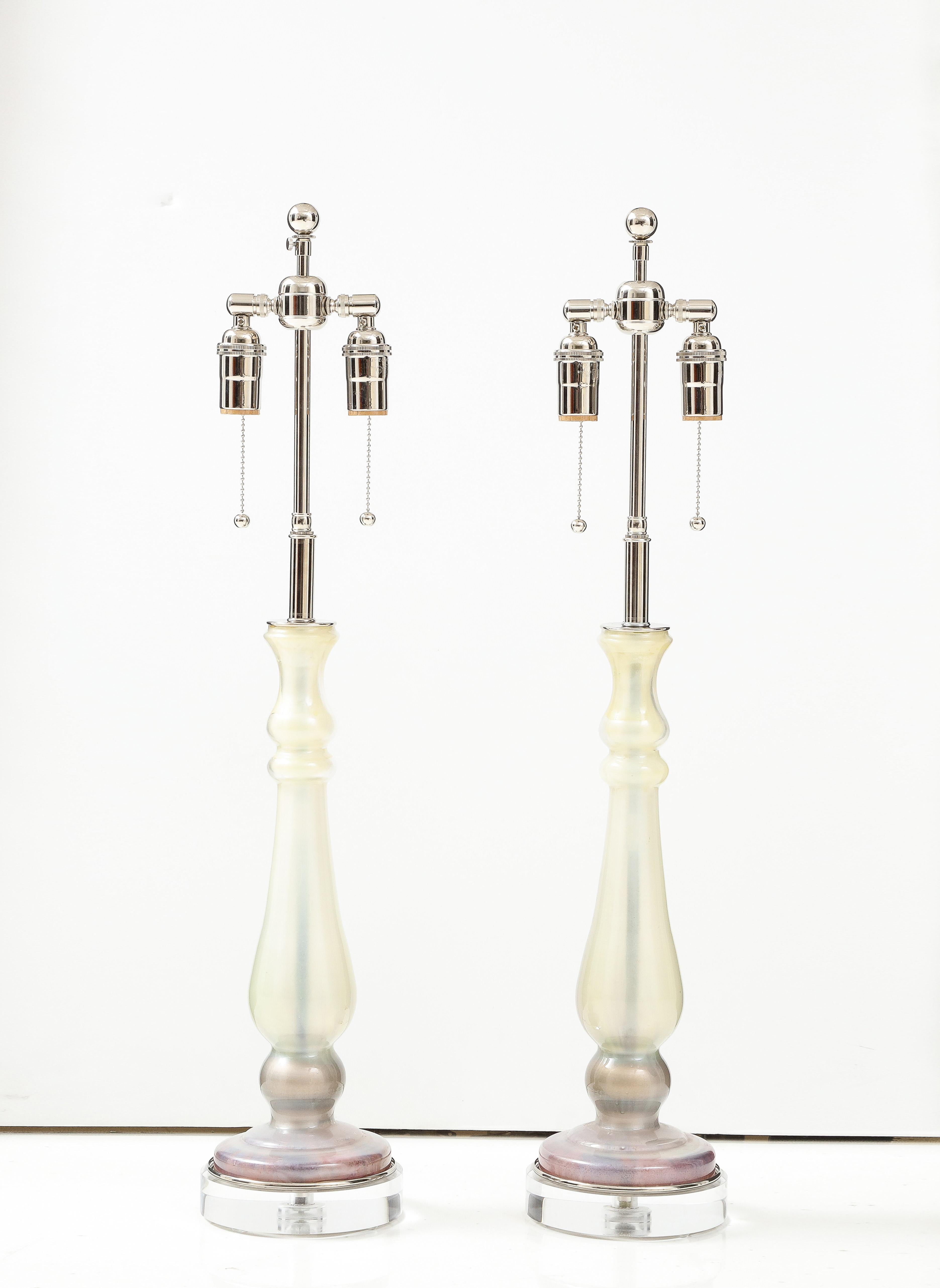 Pair of candlestick glass form lamps in shades of Ivory. Mauve and Gray.
The lamps are mounted on thick lucite bases and they have been Newly rewired with adjustable polished Nickel double clusters that take standard size light bulbs.
The height to