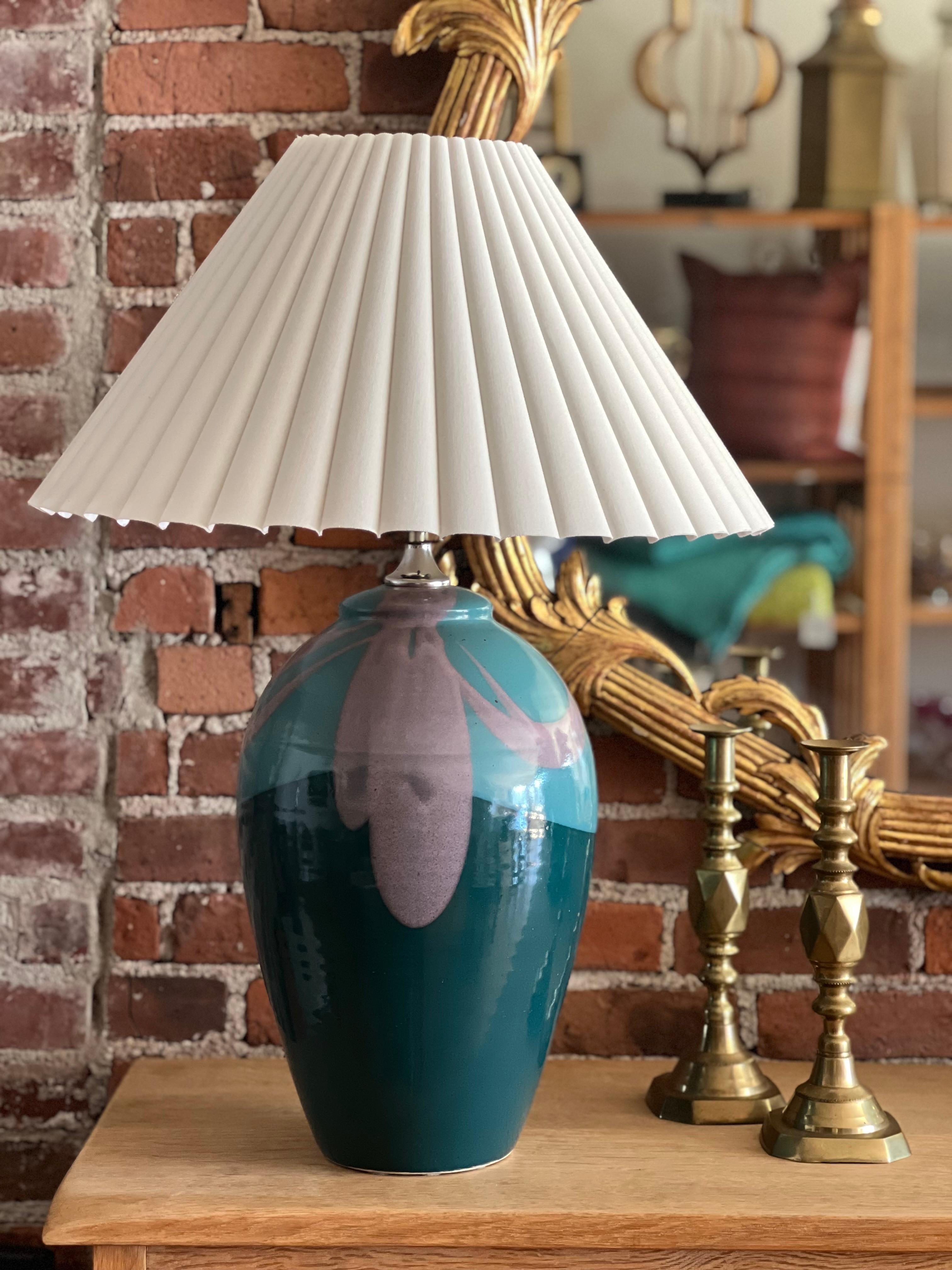 Striking pair of 1980's, handmade, glazed pottery lamps finished in saturated teals and lilac. Handmade by accomplished potters, Rick and Anne Petteford in their studio in Sebastopol, CA. Signed on the bottom. Pleated shades are included and shipped