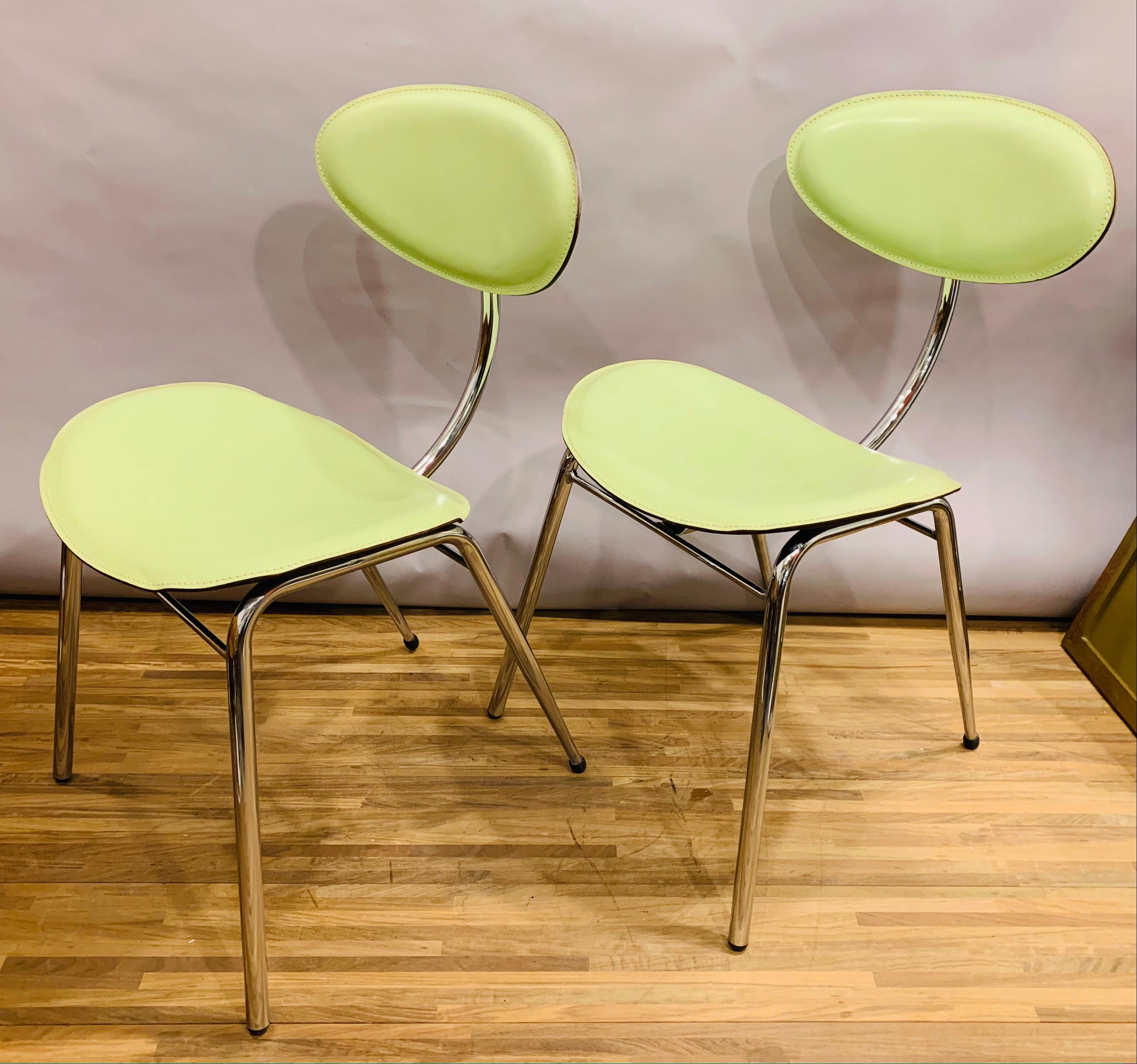 Post modern pair of 1980s Italian dining chairs manufactured by Arrben. The chairs are constructed from a slender yet solid, chromed-steel, frame. The seat and backrest are upholstered in their original lime green leather with stitching detail. The