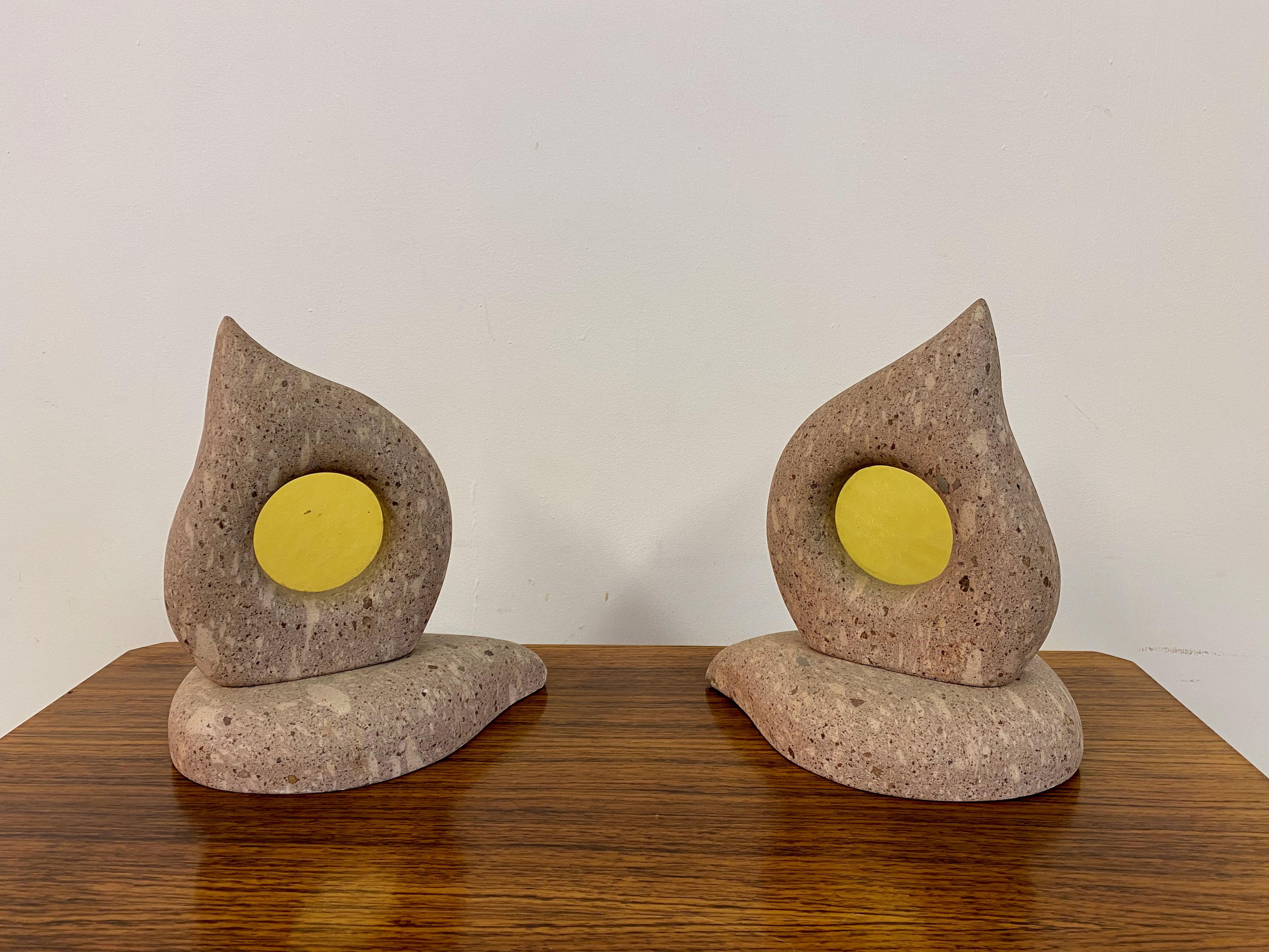 Pair of table lamps.

Travertine or similar stone.

Yellow glass shade inserts.

Shaped like a flame.

1980s Italy.