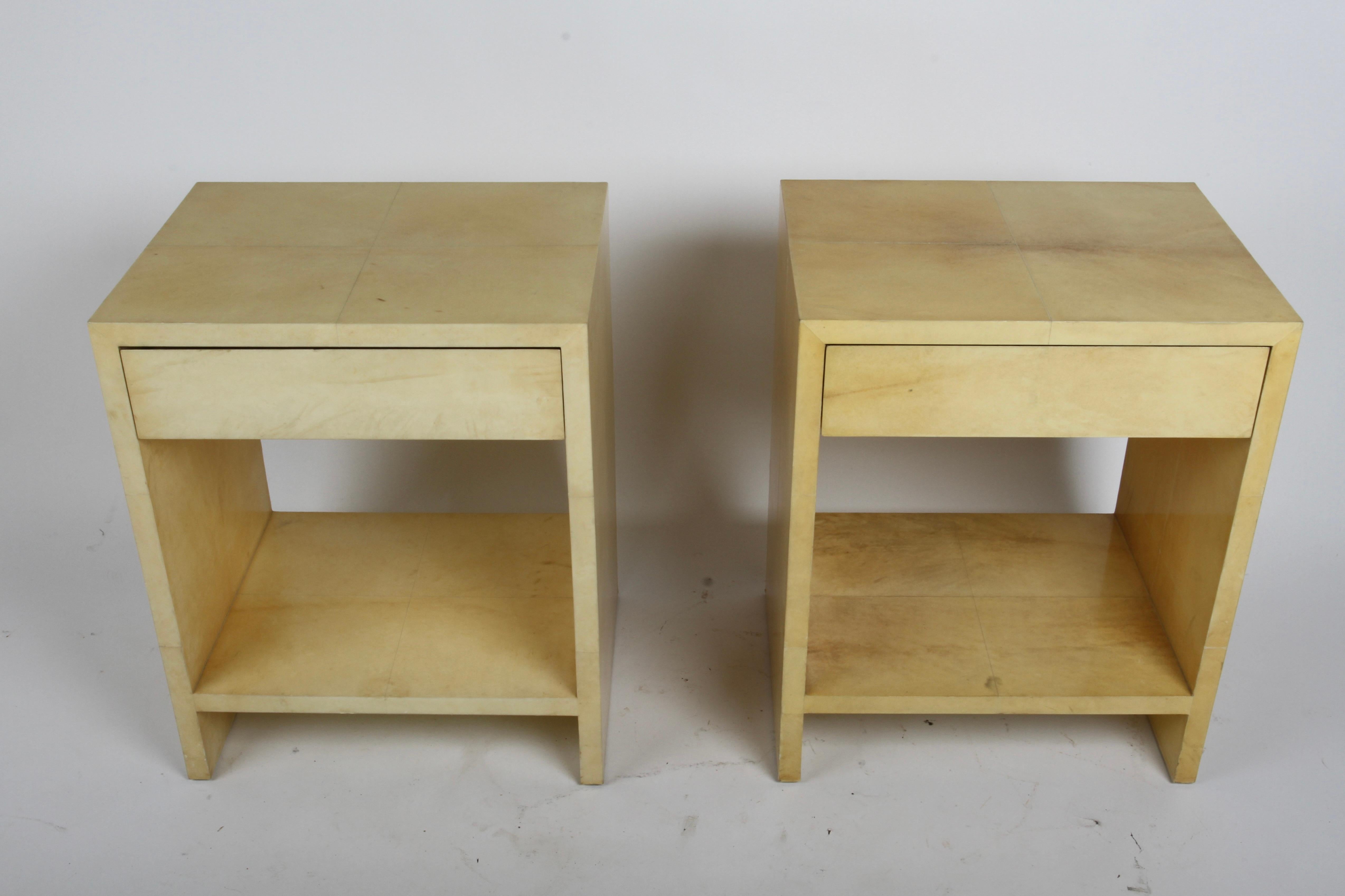 Excellent scale and form, well built pair of nightstands or end tables by Henredon with drawer. These are covered in warm colored goat skin parchment in the Art Deco style of Jean-Michel Frank, or the 1950s style of architect Samuel Marx, Aldo Tura