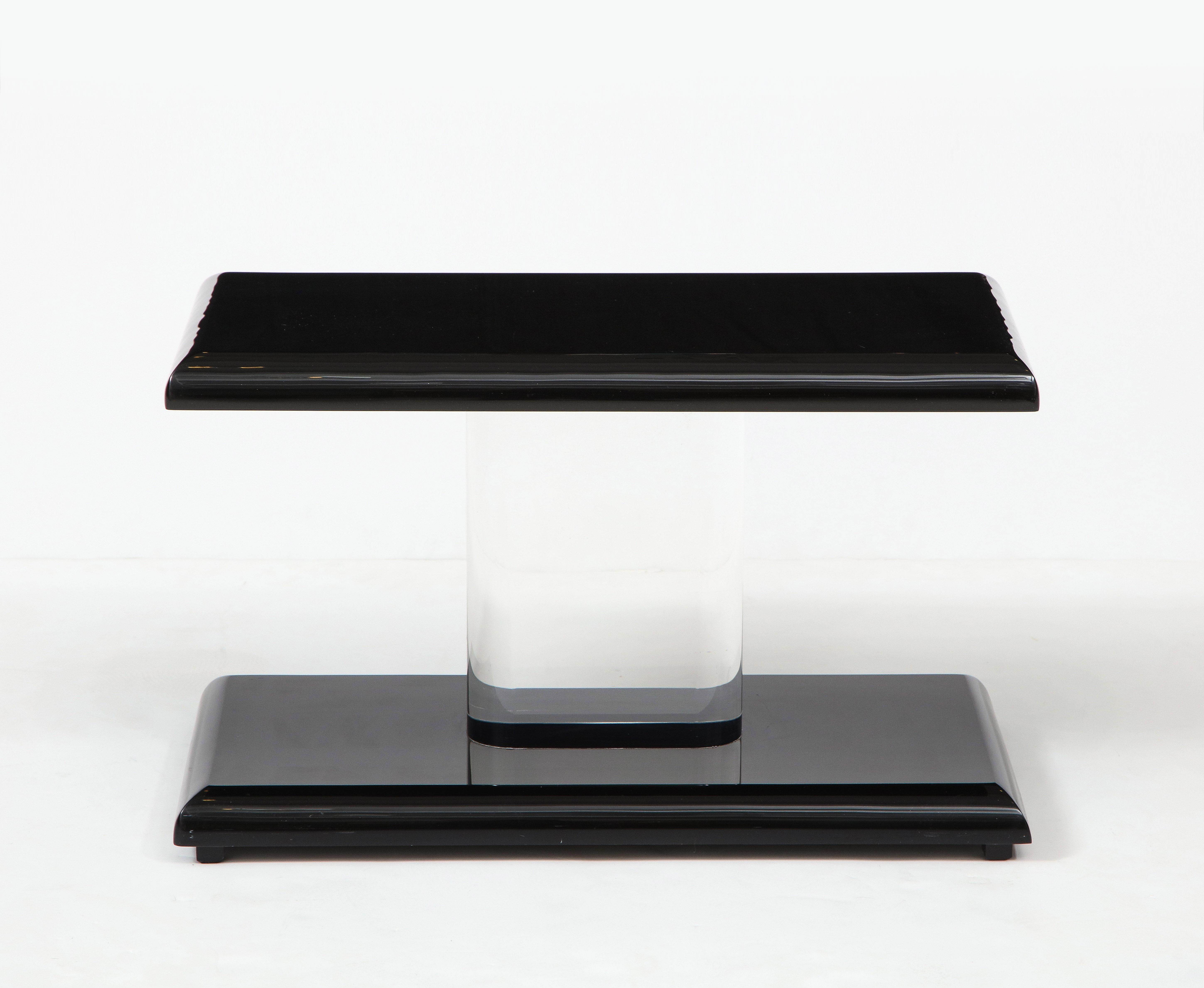 Pair of 1980's black acrylic and Lucite low side tables.
The bull nosed edge tops and bottoms are supported by a thick lucite column support.
The tables are in very good vintage condition with light age appropriate wear.
  