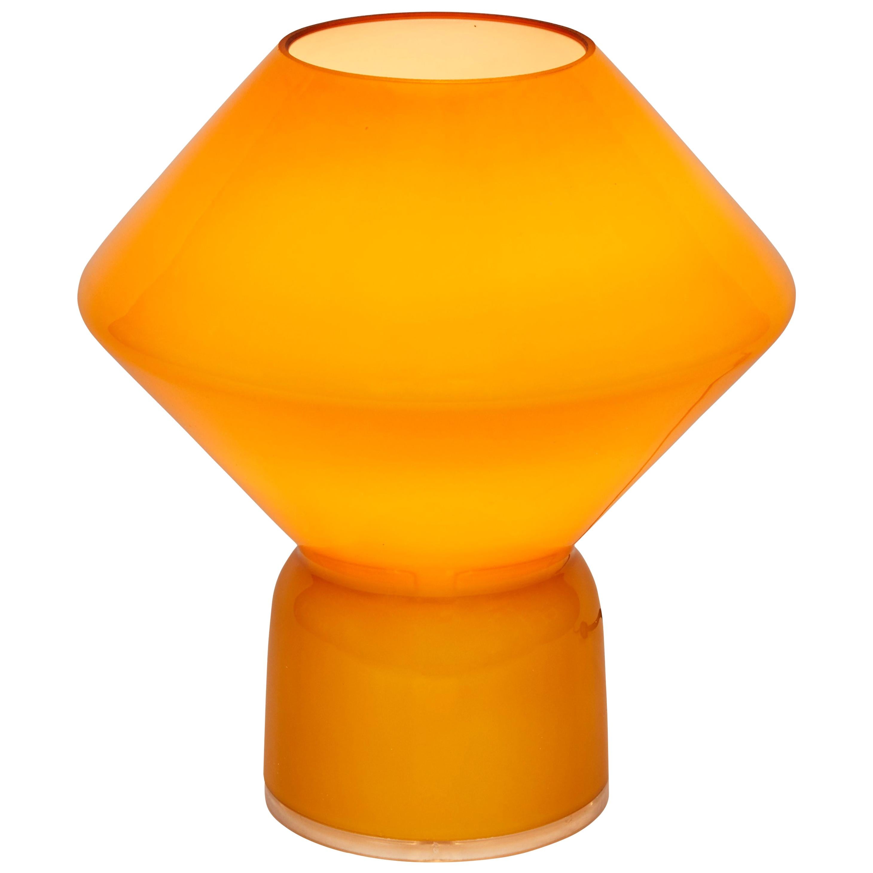 Pair of 1980s Memphis style 'Conica' table lamps for Artemide. Retains original manufacturer's sticker and factory box. Designed by Alessandro Mendini. Handcrafted in Murano amber glass, this petite lamp is strongly associated with the 1980s Memphis