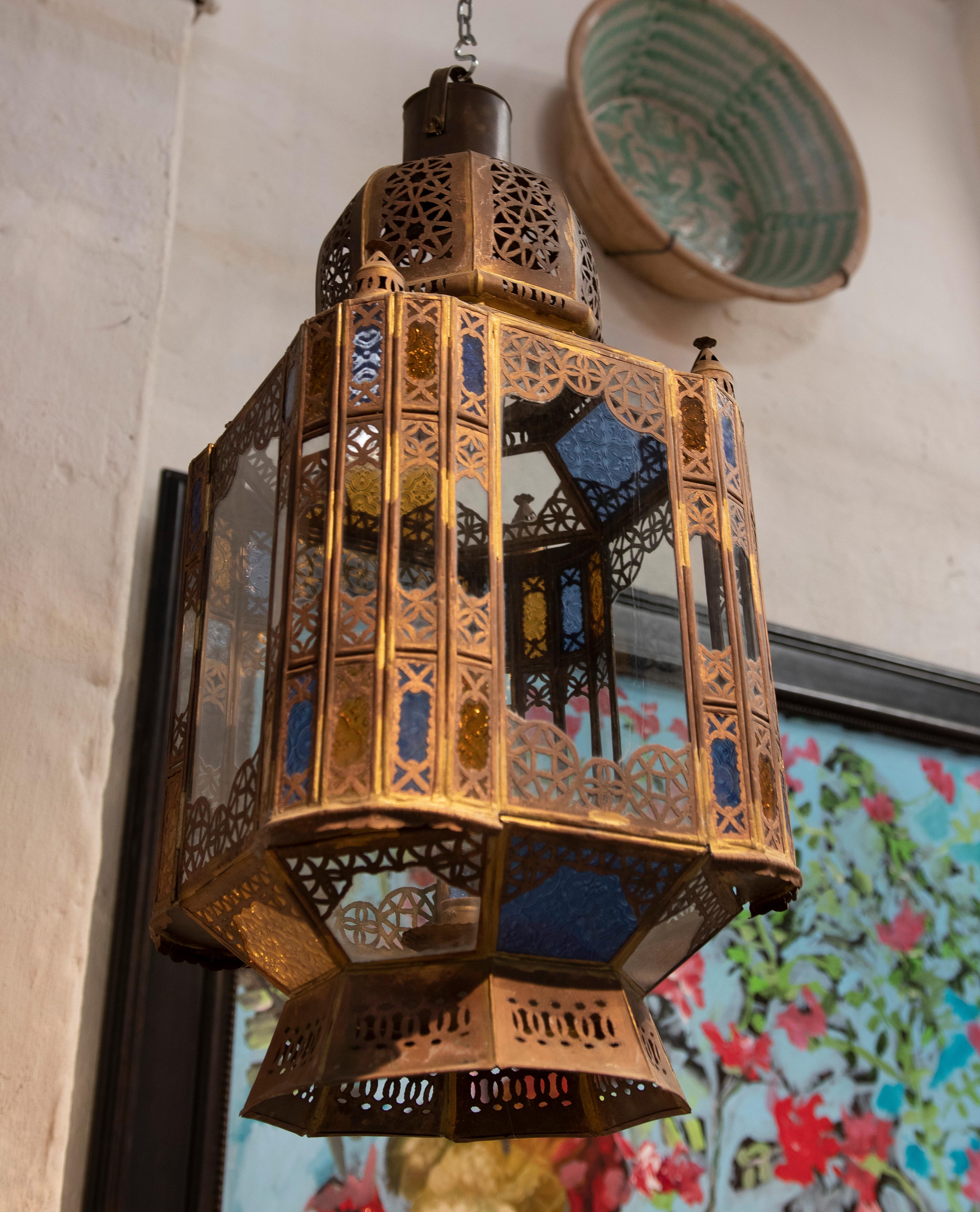 Pair of ethnic 1980s Moroccan iron hanging lantern lamp with coloured glass.