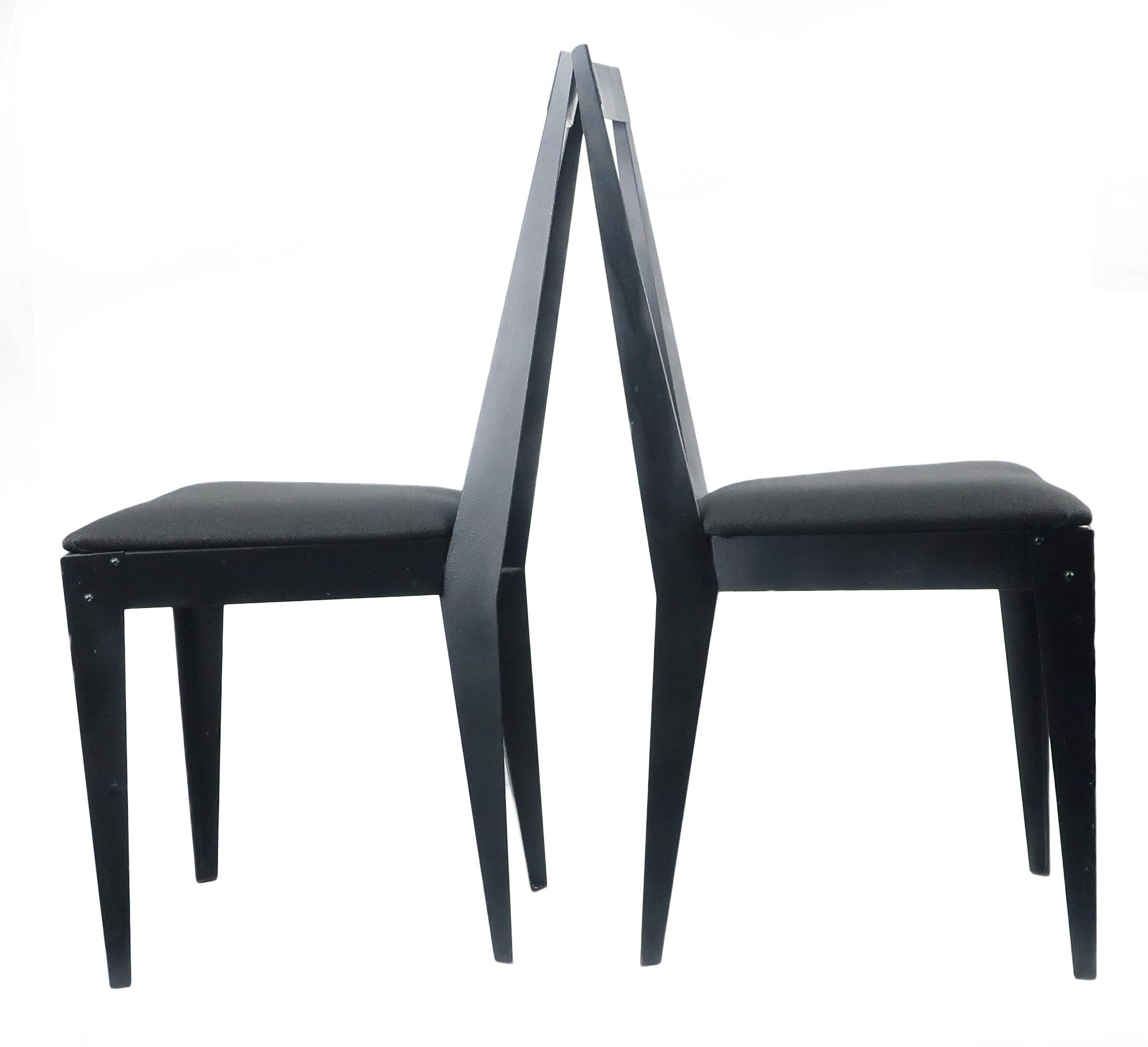 A eye-catching pair of sleek 1980s post modern angular side chairs. The Minimalist frames are all metal and seats are newly reupholstered in a vintage black upholstery.

In good vintage condition with light signs of wear consistent with age and