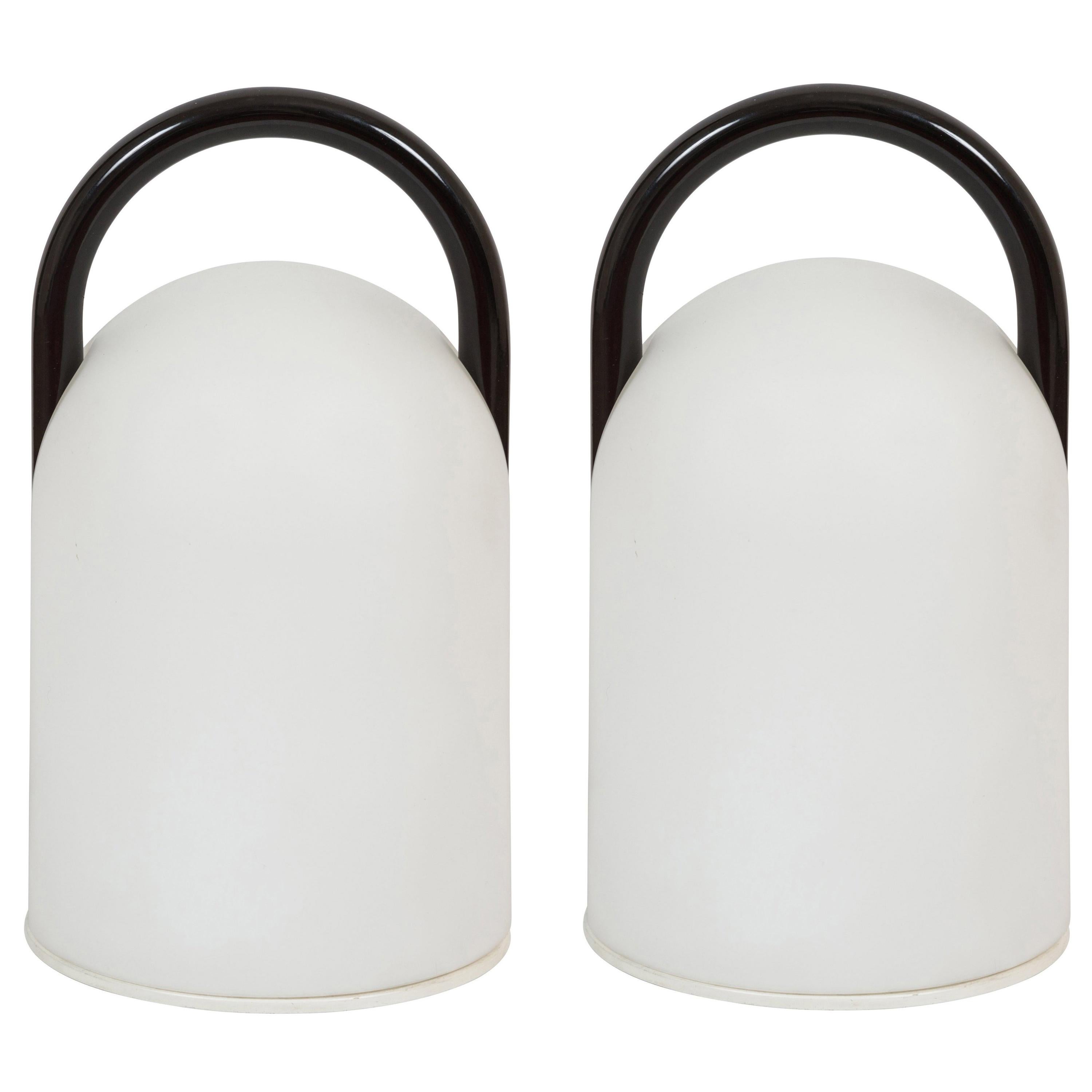 1980s Romolo Lanciani black 'Tender' table lamps for Tronconi. Executed in opaline glass and black enameled metal, Italy, circa 1980s. A surprisingly refined and minimal design, especially for its time and place. 

Price for a pair. Three lamps