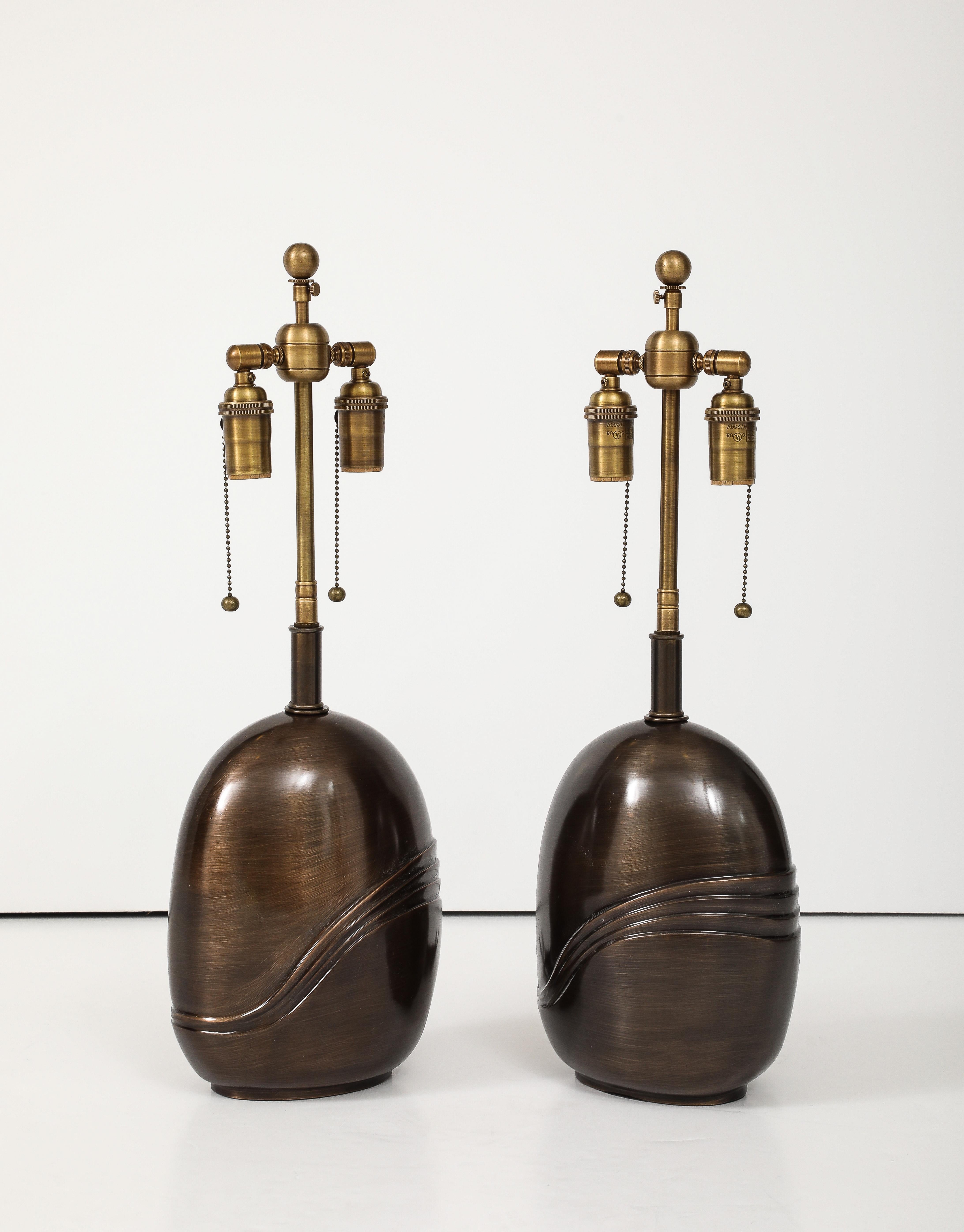Pair of  1980's Solid Bronze lamps by Esa fedrigolli.
The lamps have a beautiful Antique Bronze finish and they have been Newly rewired with adjustable Bronzed finished double clusters and silk rayon cords.
The Overall height to the finial is 23.5