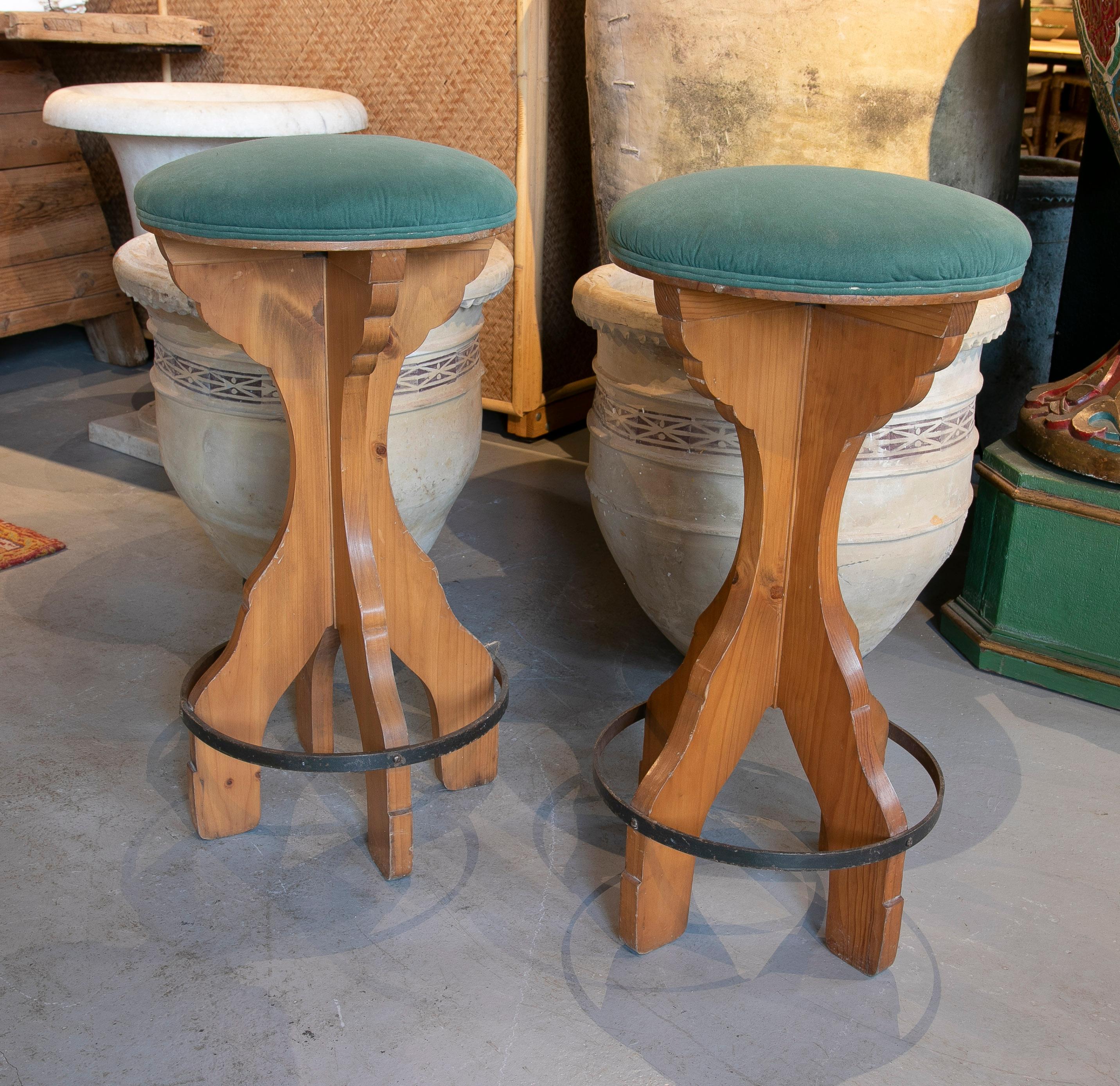 Pair of vintage 1980s Spanish wooden stools with teal upholstered seats.