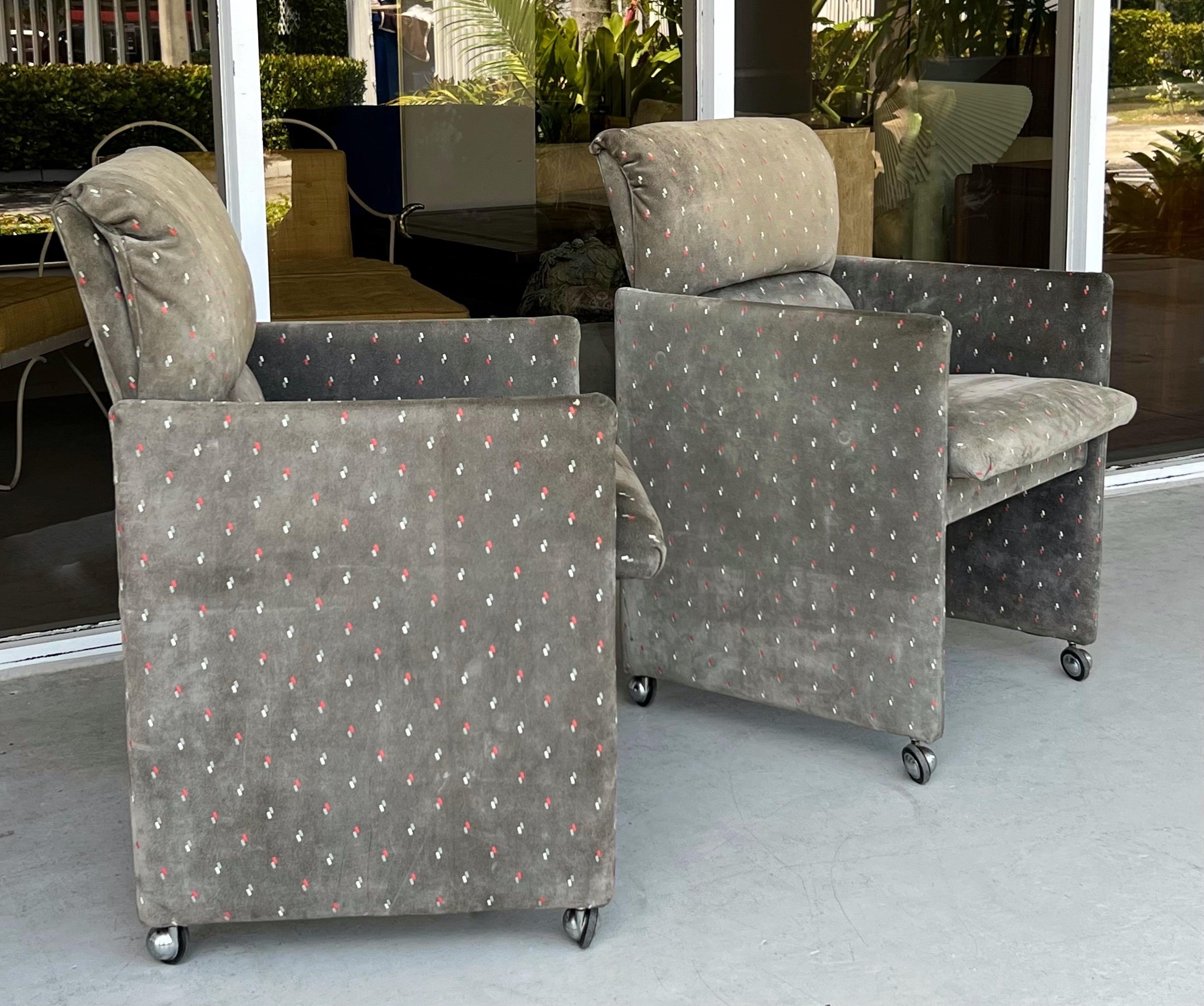 A pair of arm chairs in gray suede. 
