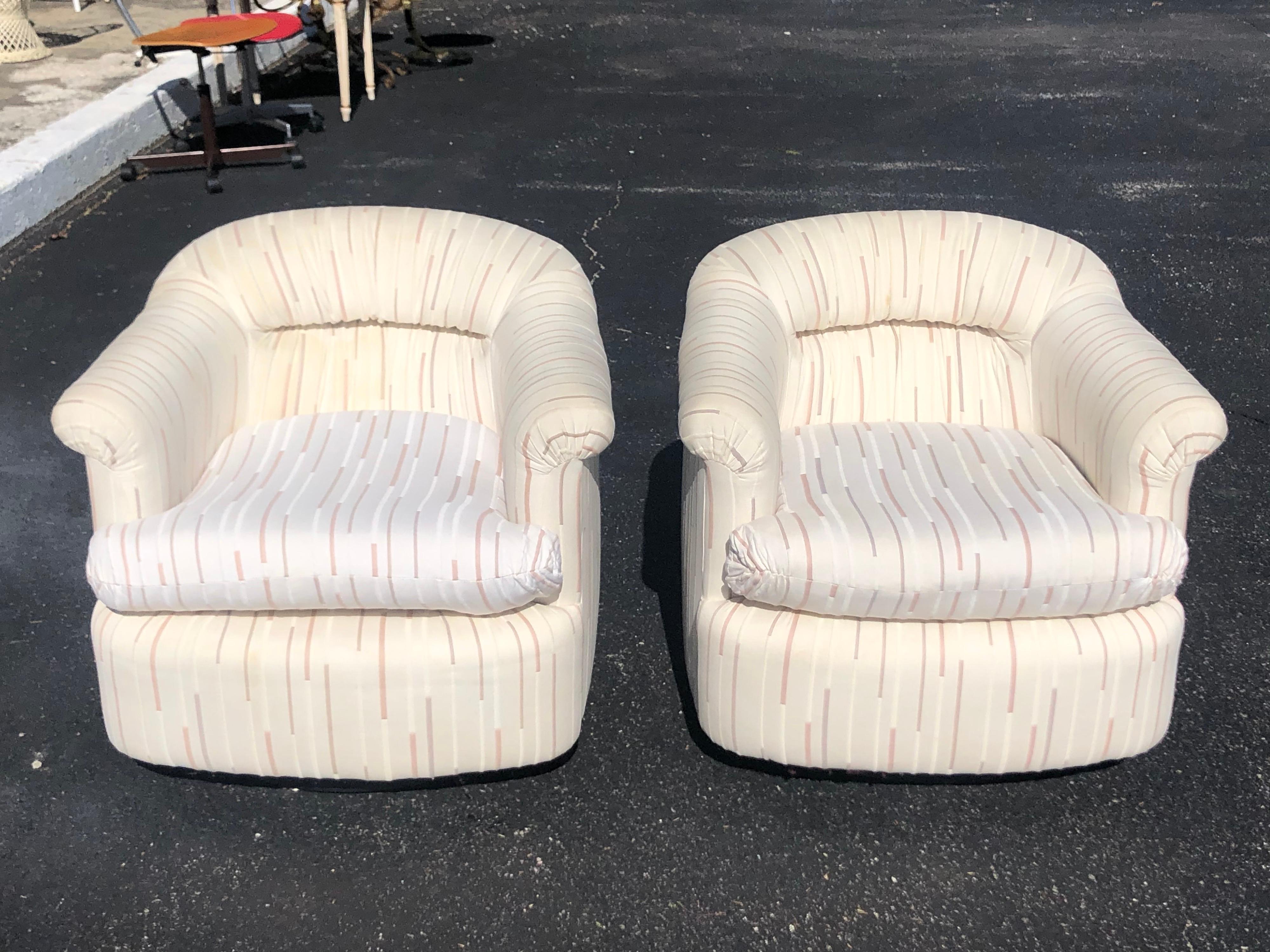 Pair of 1980's Swivel club chairs. Fun, comfortable, designer chairs. Seat depth is 20