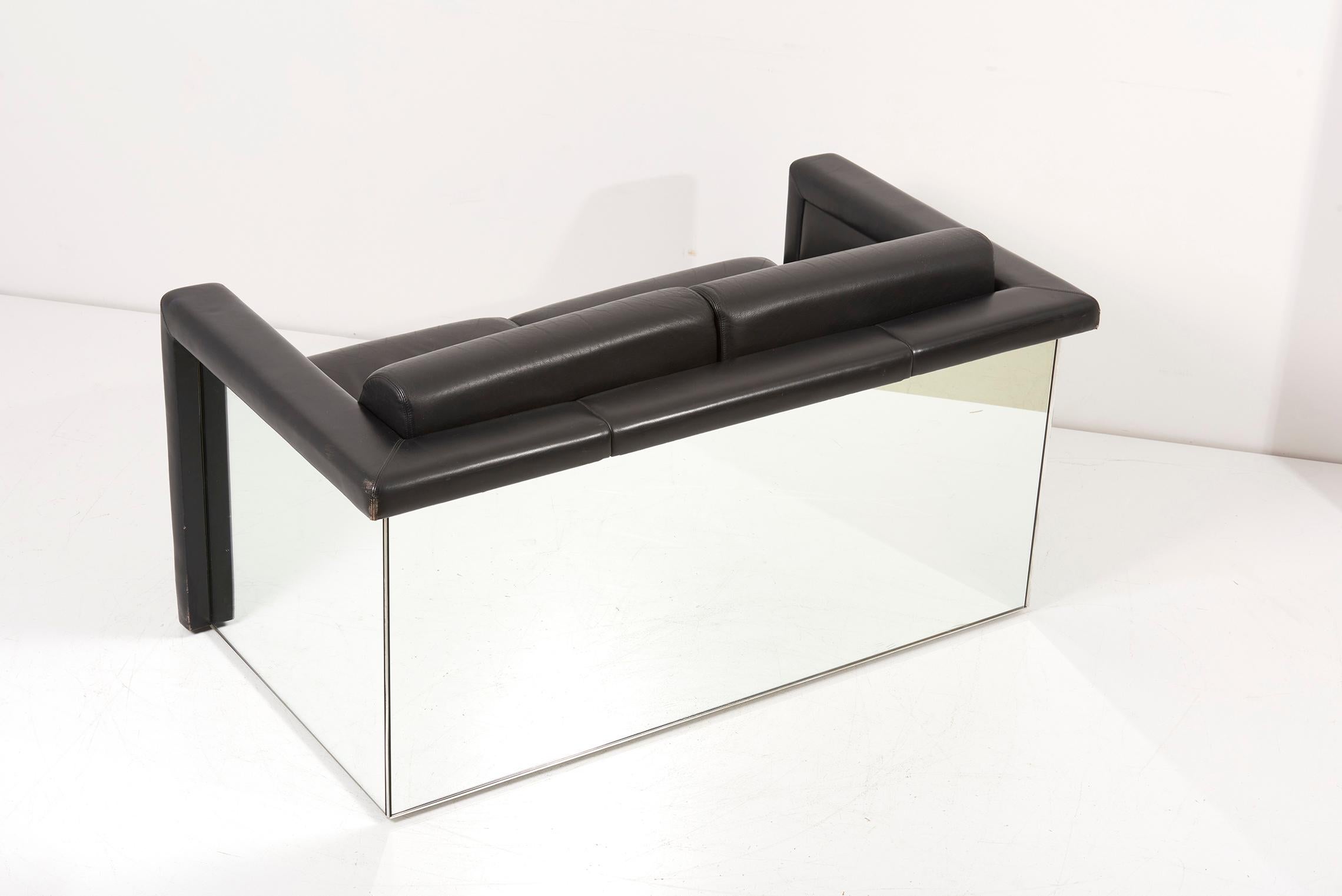 Pair of 1970s Trix & Robert Haussmann for Knoll 2-seat sofa settee. This pair is made in black leather and mirror. All original collectors condition. The Mirror Sofa and Chairs is a furniture collection designed by German architect and designer,