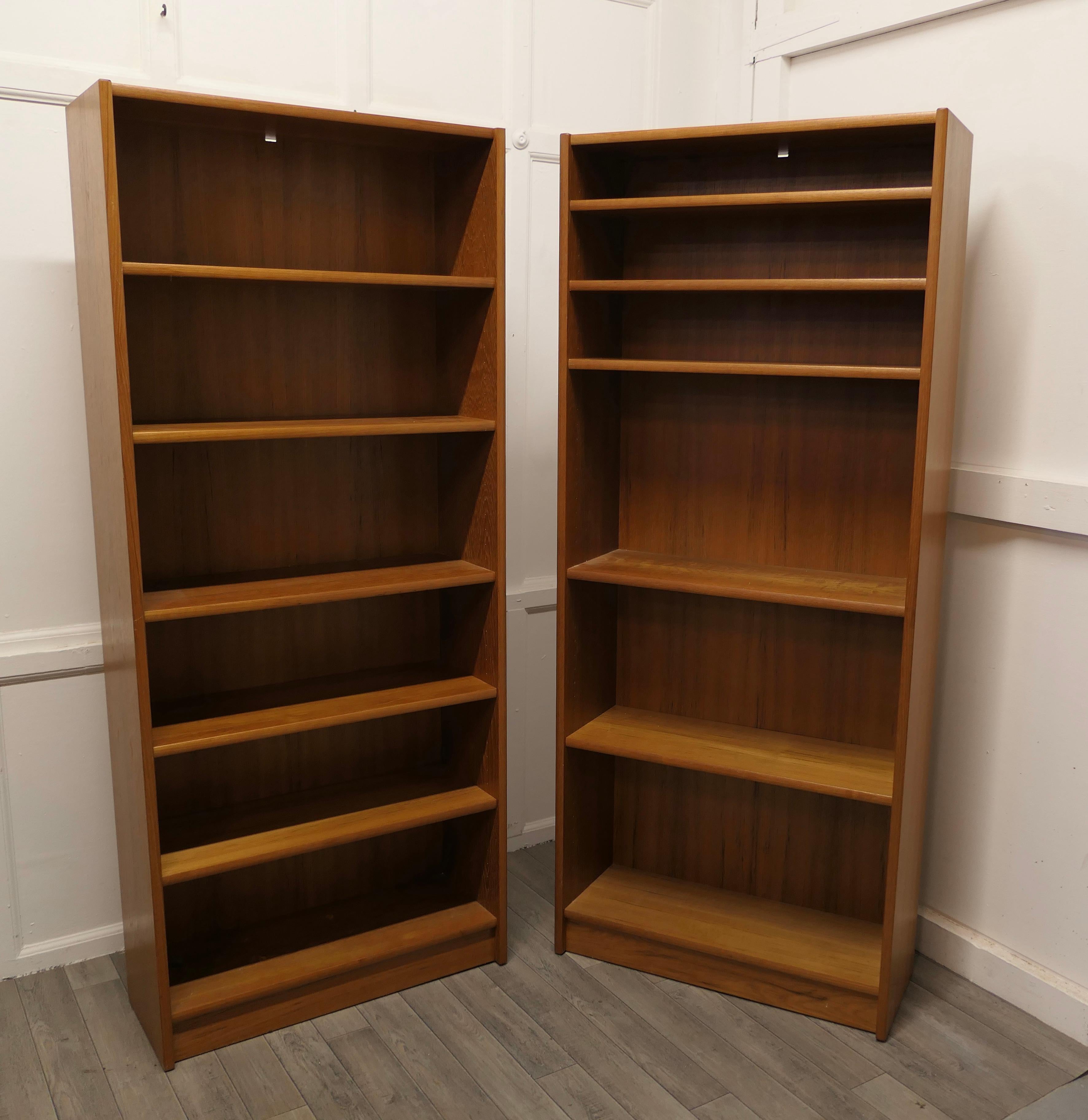 Pair of 1980s vintage tall open book cases in teak finish

This is a classic timeless design the bookcases are sturdy and heavy, they each have 5 adjustable shelves and wooden panelled backs 
All in all 2 very good architectural pieces which will