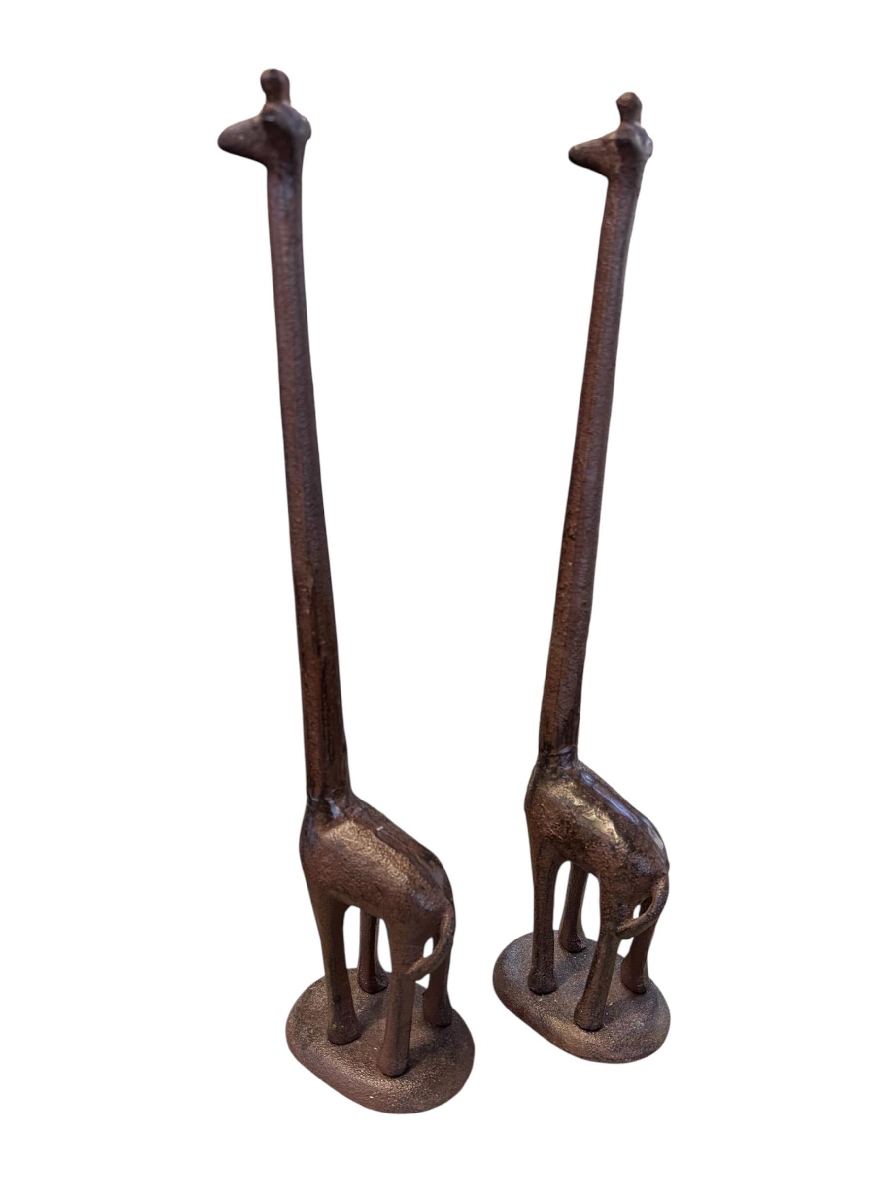 Celebrate whimsical elegance and artistic craftsmanship with this striking pair of 1980s wrought iron giraffe sculptures. Each sculpture features a minimalist yet expressive design, with dramatically elongated necks and stylized, slender bodies that