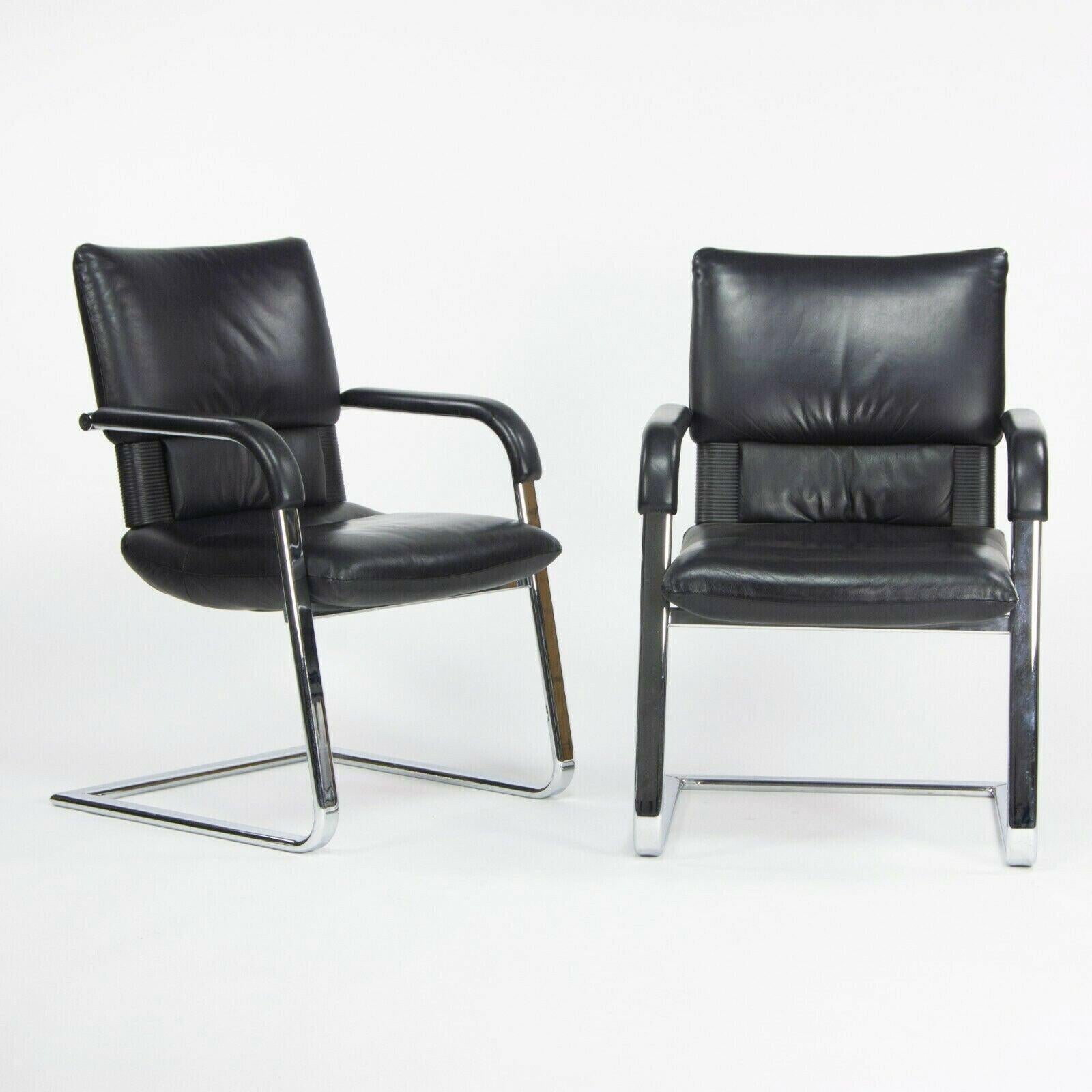 Listed for sale is a pair of vintage 1986 Vitra Figura arm chairs, designed by Mario Bellini. These are gorgeous original examples, which retain their original black leather upholstery. The chairs were likely used a side chairs in an executive