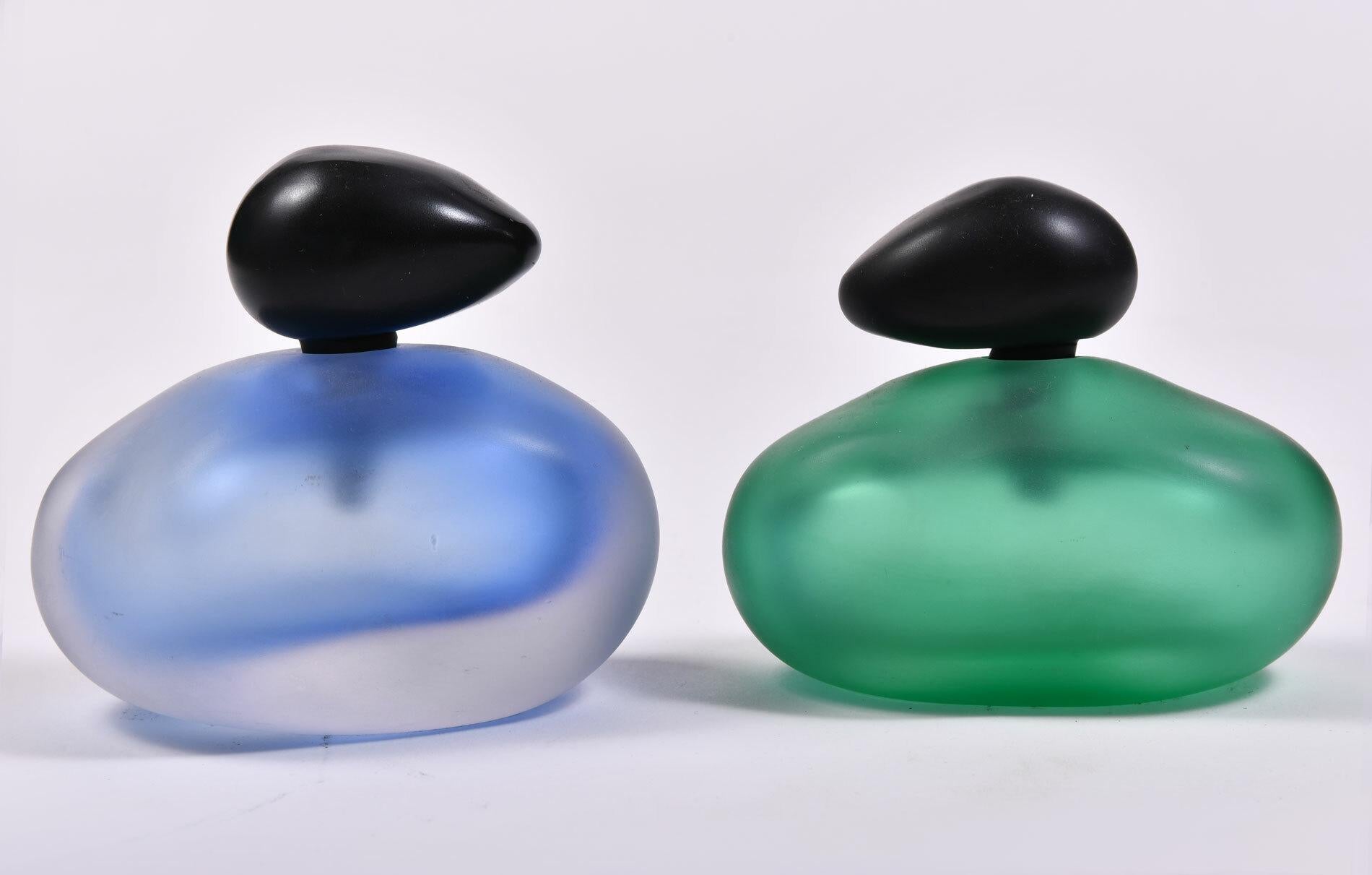Organic stone shaped pair of blue and green Murano perfume bottles with black glass stoppers.