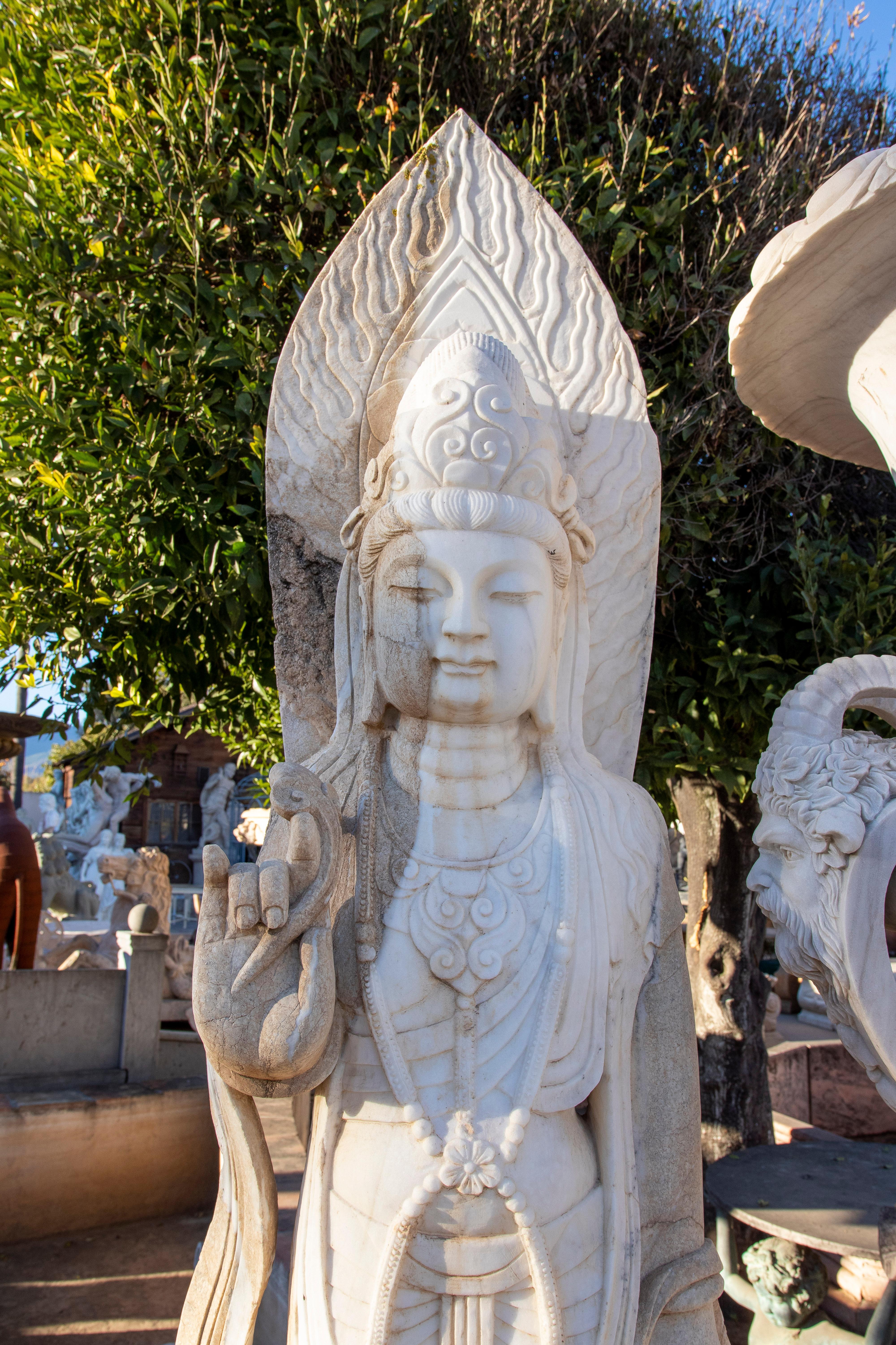 Pair of 1990s Chinese hand carved monumental larger-than-life white marble standing Buddhas.