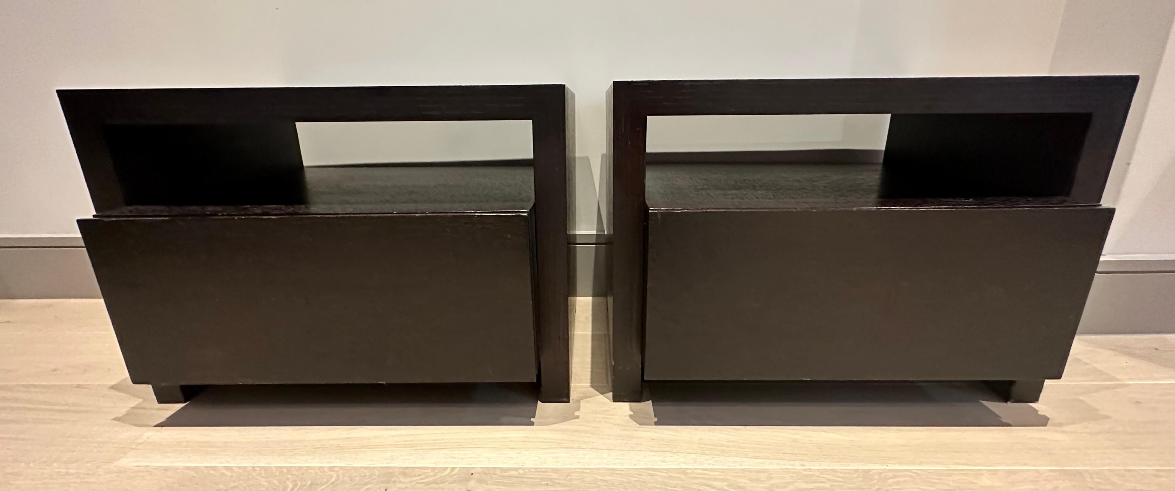 A pair of very well made dark chocolate brown veneered oak bedside tables or nightstands with a single central deep drawer.  Custom made in England in the 1990s.  Simply designed with a single pull drawer with no handle. Stained with a dark brown