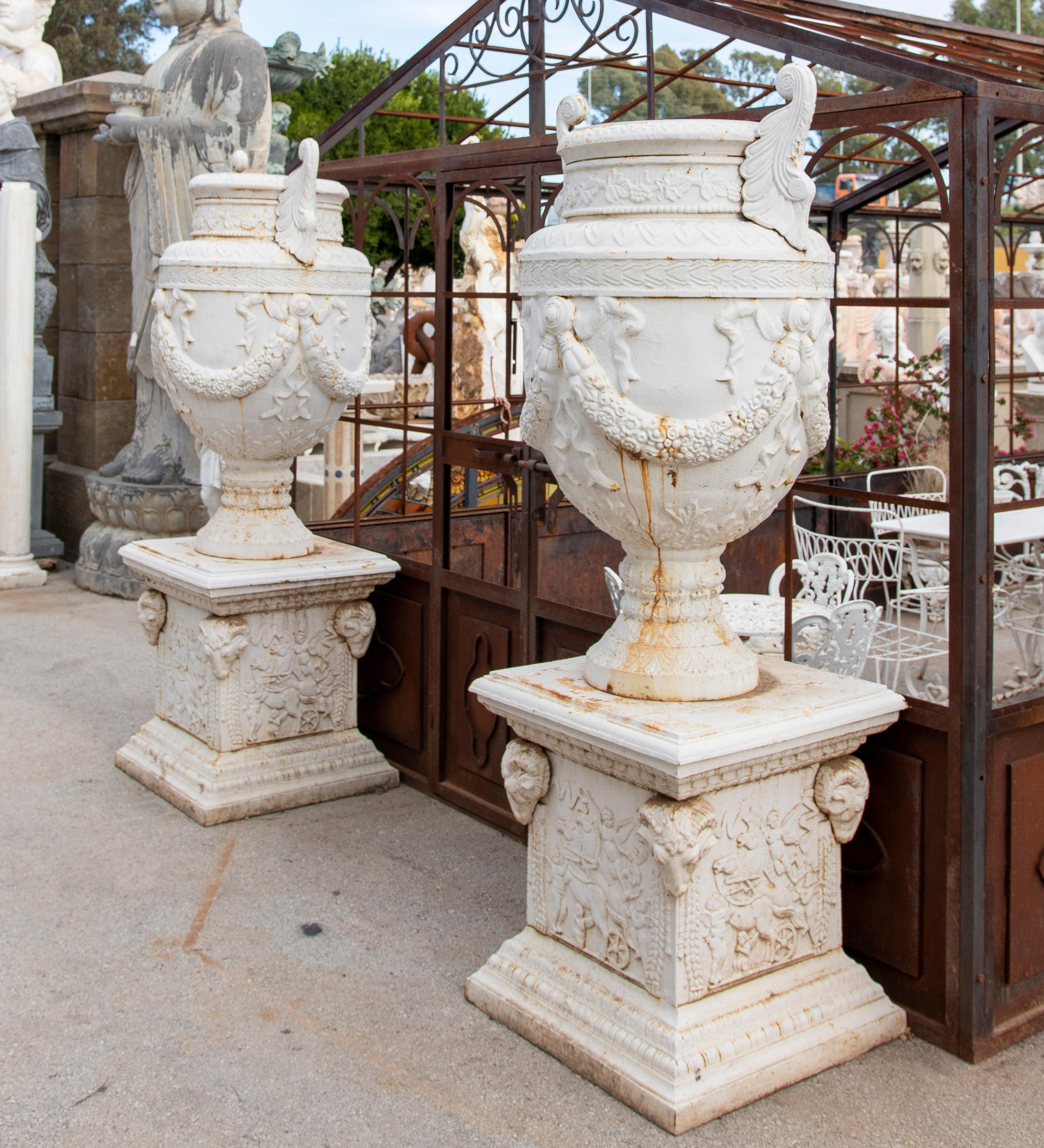 Pair of classical 1990s French monumental cast iron garden planter urns with plinth bases, painted white.