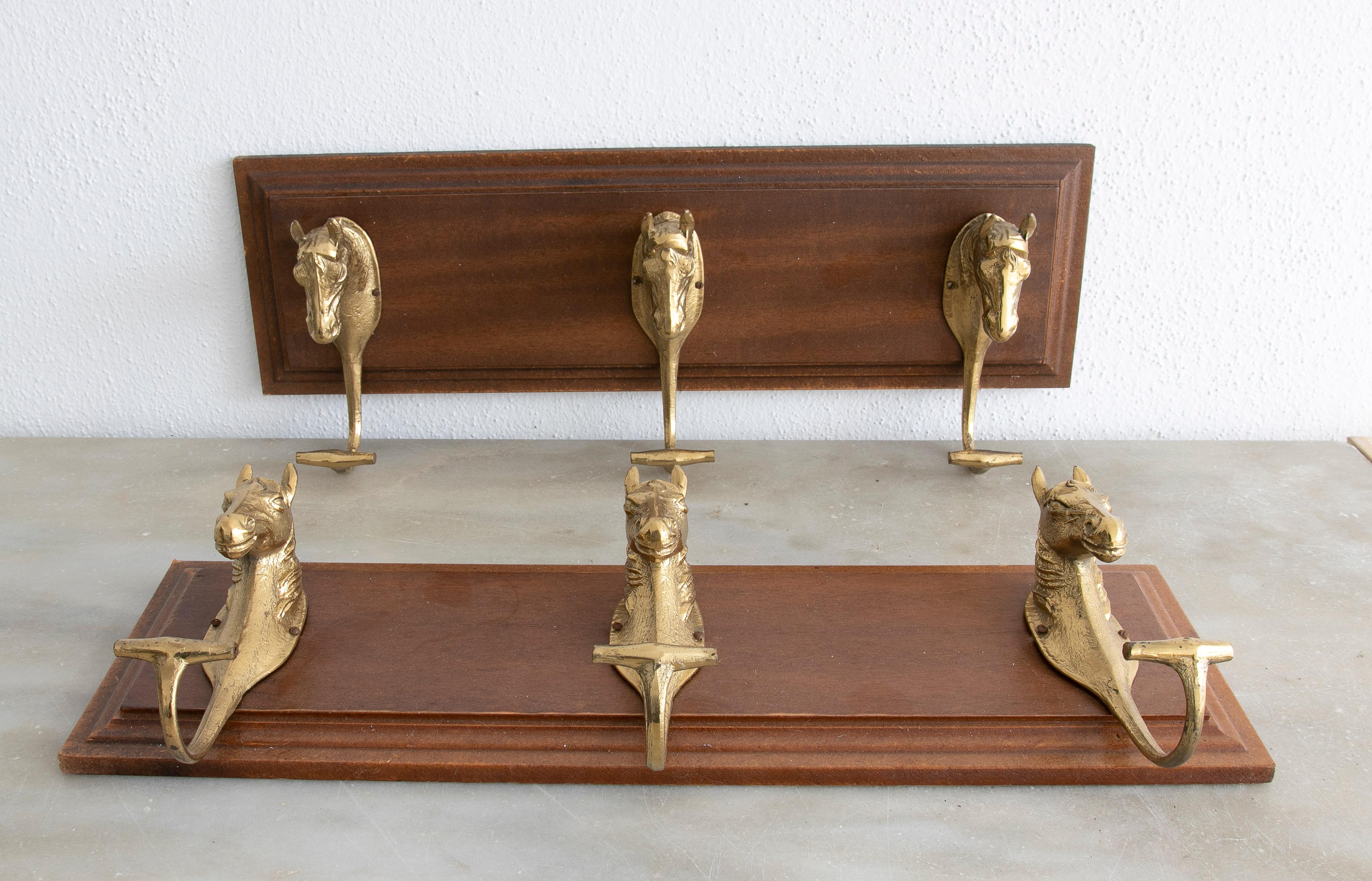Pair of 1990s Spanish wood and bronze 3-hook coat hanger. Each hook has been cast a a horse figure head.