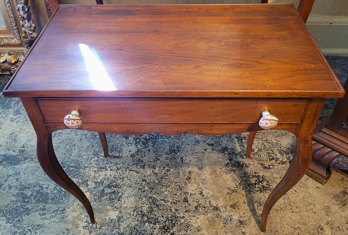 PRESENTING a LOVELY Pair of 19C French Country Cherrywood Side Tables.

Not a fully ‘matching’ pair, but very similar and have been together since the 1930’s (at a minimum).

Both made of cherrywood.

One large side table, with central frieze drawer