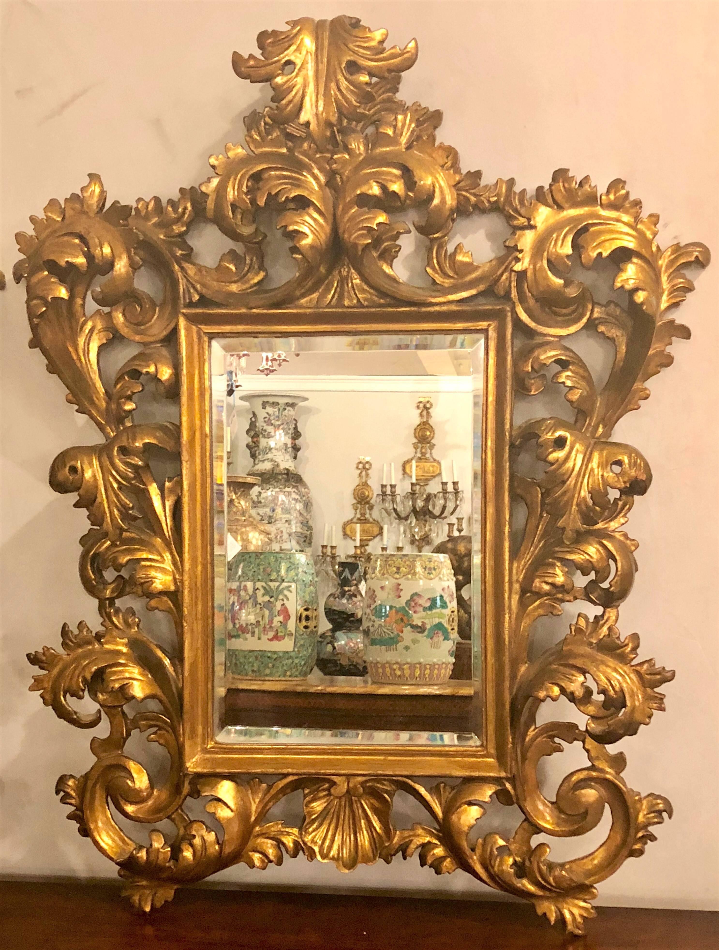 A pair of 19th century carved Italian Florentine wall or table beveled mirrors. This simply stunning pair of small wall or easily converted table mirrors have wonderful size and display themselves with all the glamour anyone could possibly expect.
