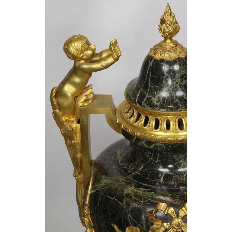 Early 20th Century Pair of 19th-20th Century Louis XVI Style Ormolu and Marble Urns with Children For Sale