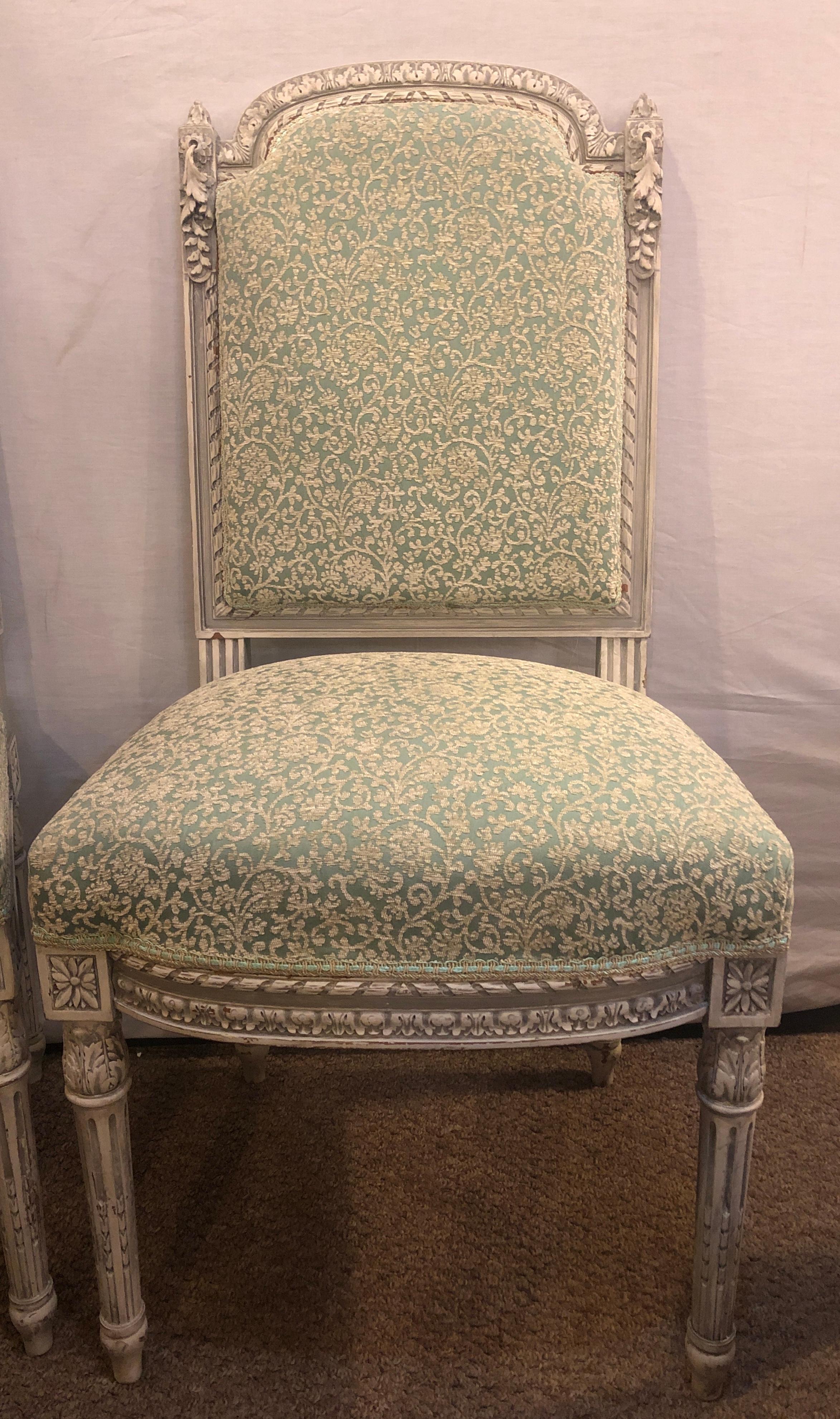 Pair of 19th-20th century paint decorated Louis XVI style Swedish side chairs. This fine pair of French Louis XVI style side chairs are stunning and the quality of the carvings and paint is unsurpassed. The simply breathtaking wood work certainly