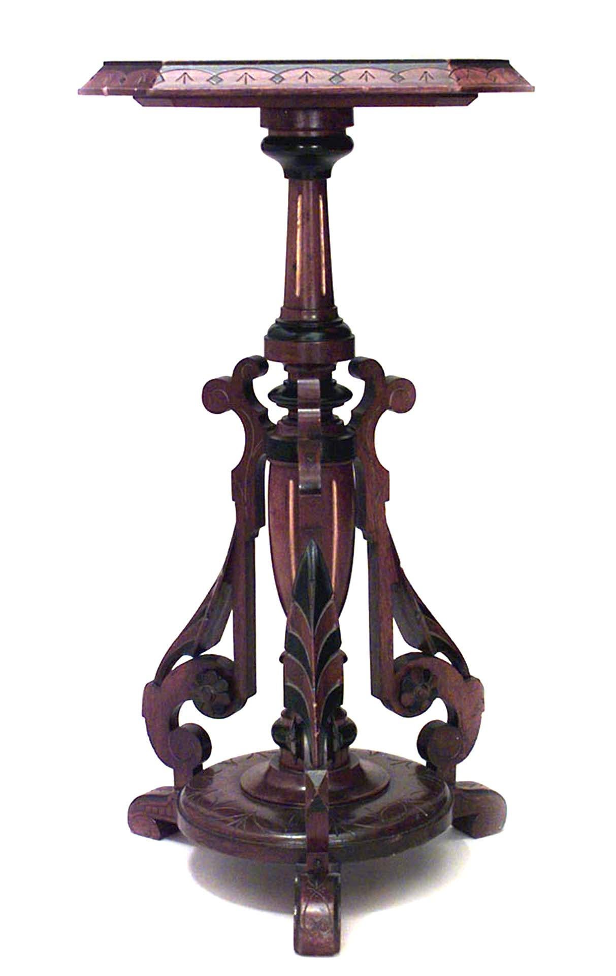 Pair of American Victorian Eastlake walnut pedestals with ebonized and gilt trim and centerpost.
