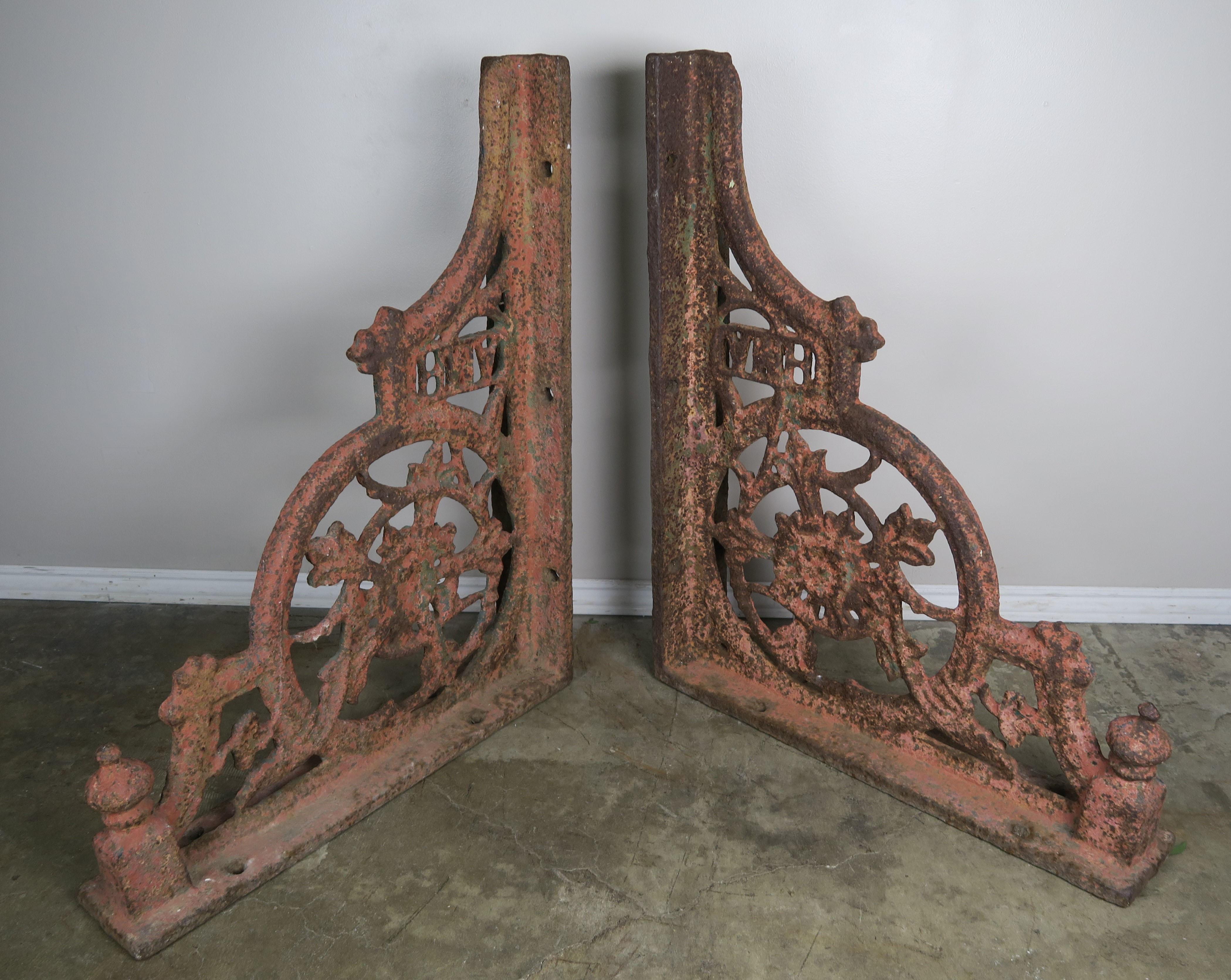 Pair of American 19th century painted cast iron architectural brackets with the initials 