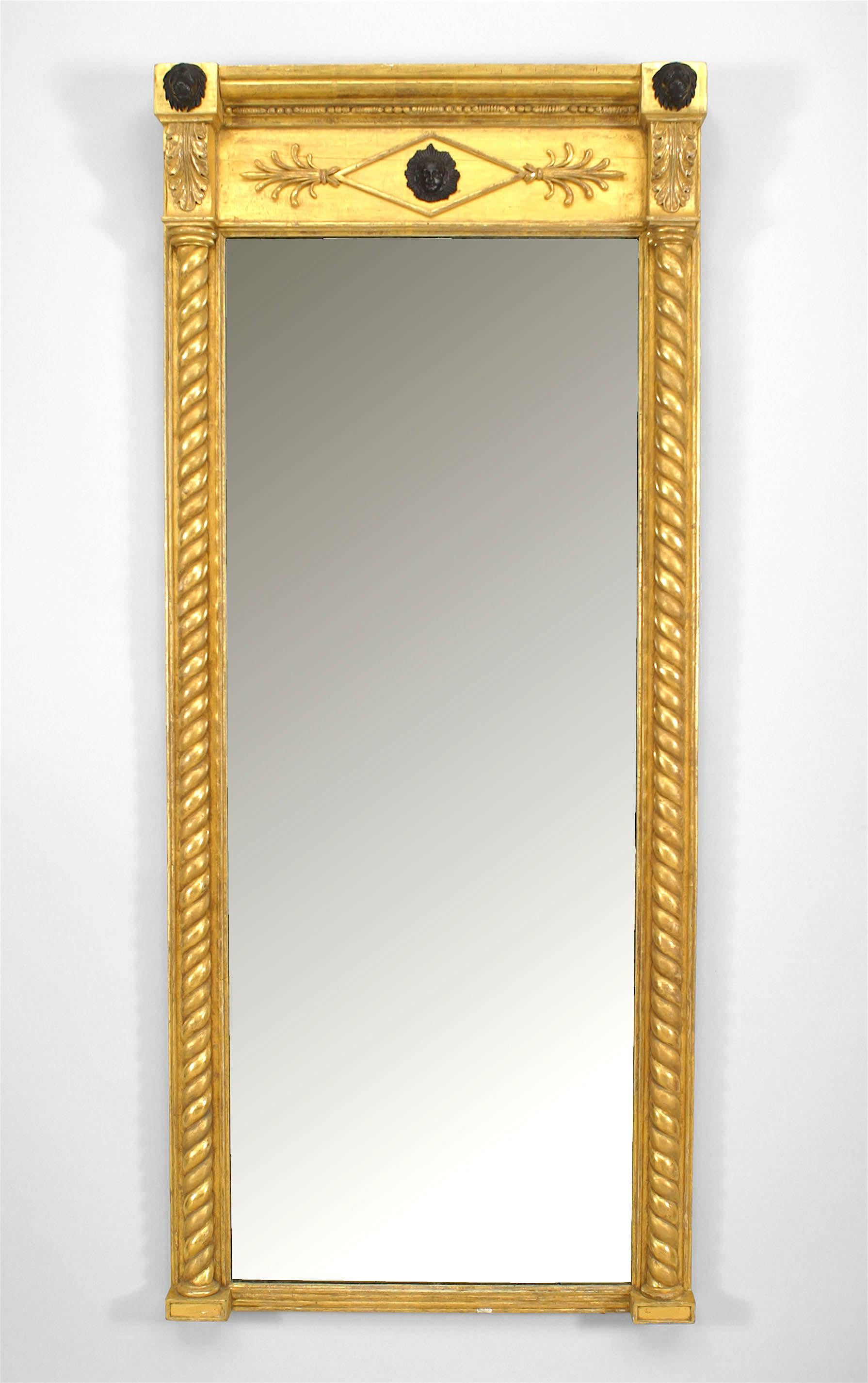 Pair of English Regency gilt rectangular wall mirrors with swirl column sides under a cornice with an ebonized female mask and two lion head ornaments. (PRICED AS Pair).
 