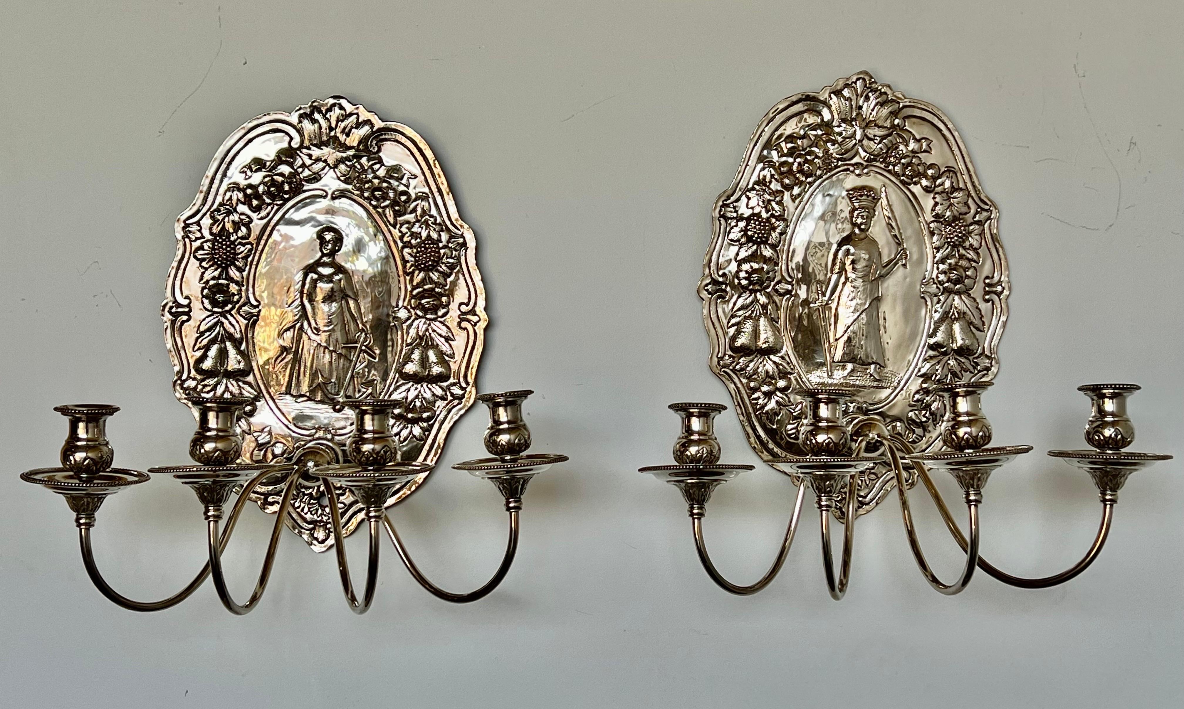 Pair of 19th C. English handmade silver plated candle sconces. The 4-light sconces are all hand hammered. They are decorated with a figure of a crowned man with swords and a detailed woman holding an anchor. The sconces are also decorated with