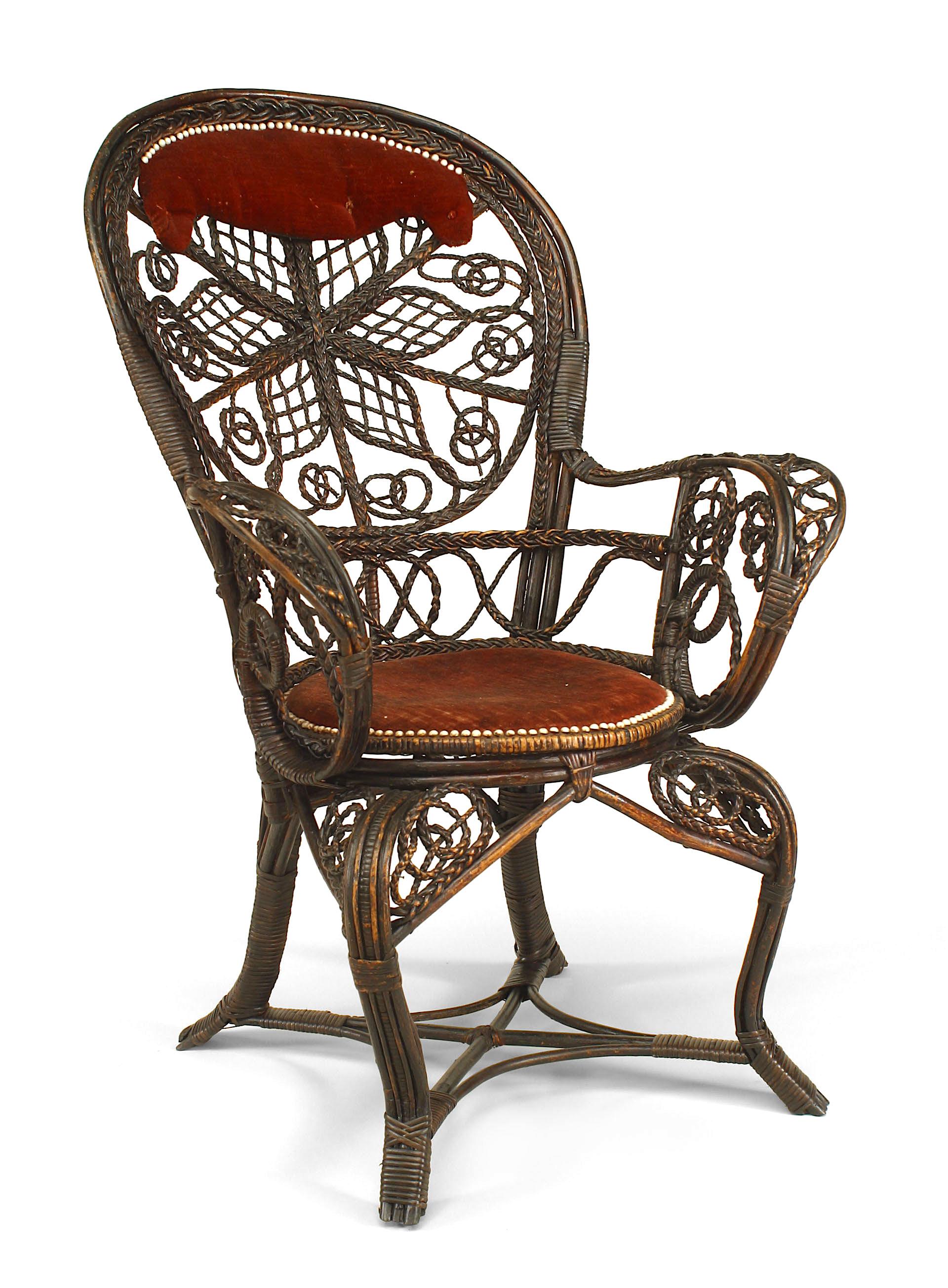 Pair of American Victorian dark stained wicker character fan back armchairs with filigree scroll design and red velvet upholstered seats and headrests. (manufactured by COLT) (PRICED EACH)
